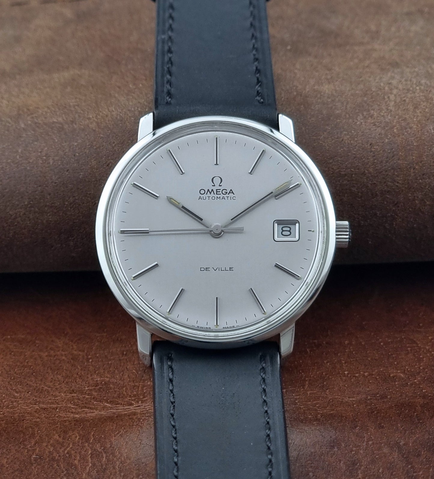 Vintage Omega de-ville wristwatch on a brown background close up dial view