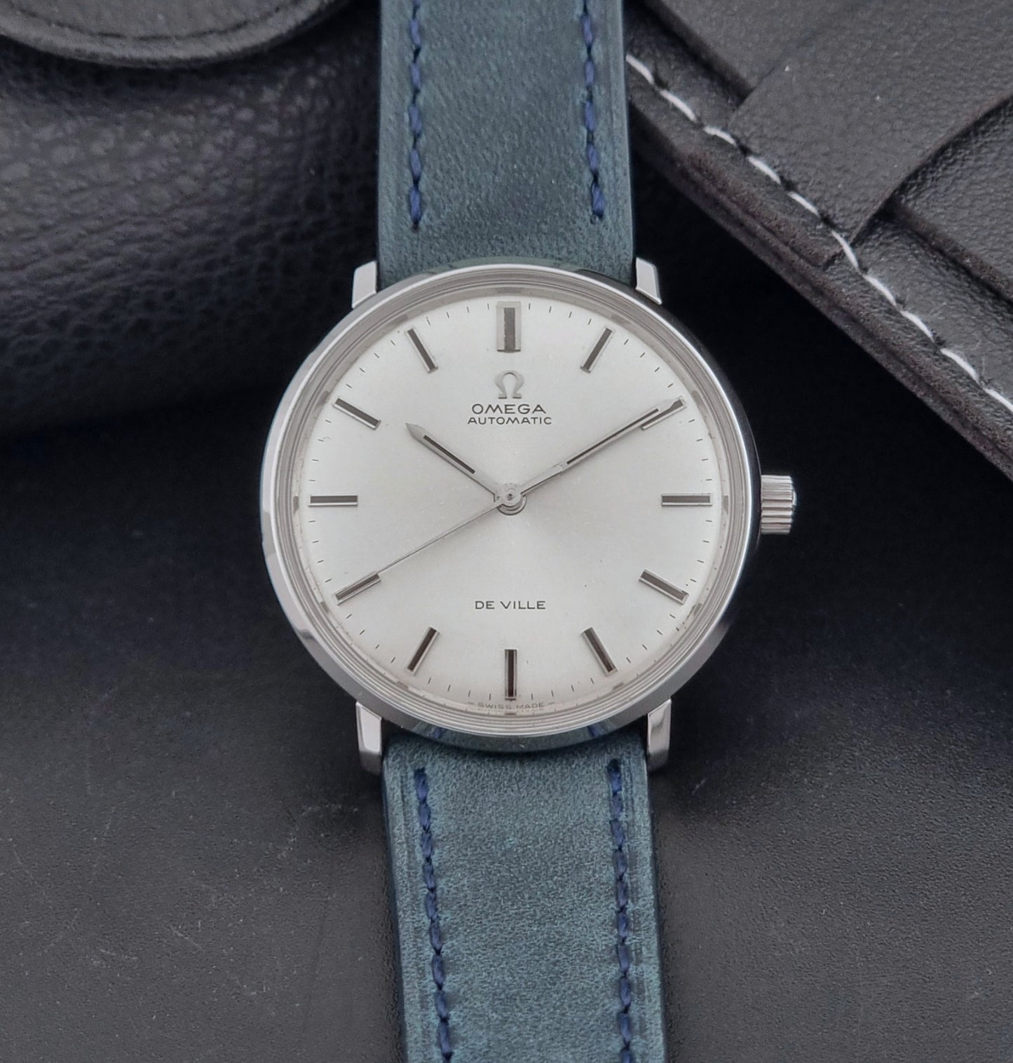 Vintage Omega Wristwatch De-Ville 165.033 with blue strap on a dark background dial view