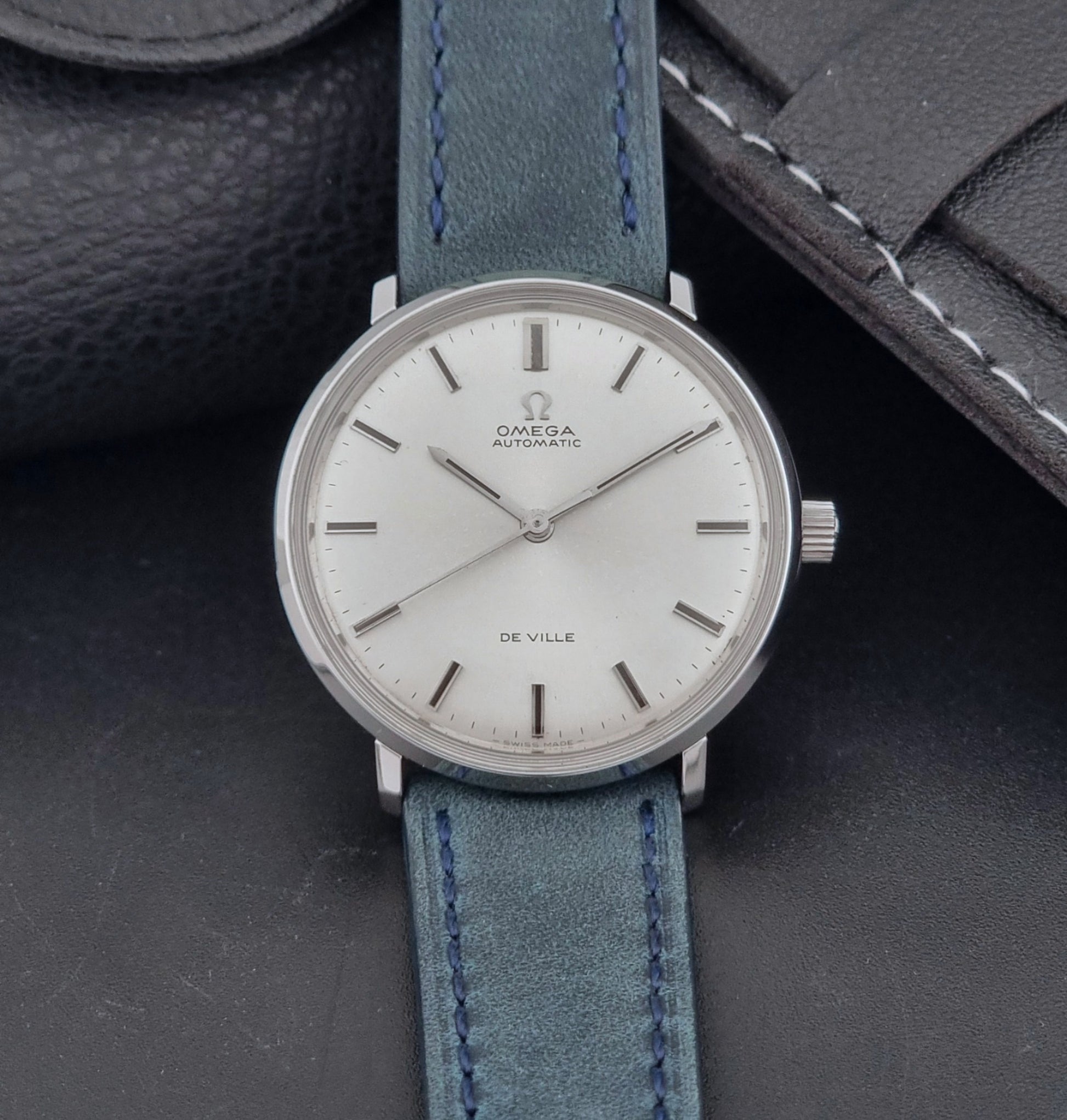 Vintage Omega Wristwatch De-Ville 165.033 with blue strap on a dark background dial view