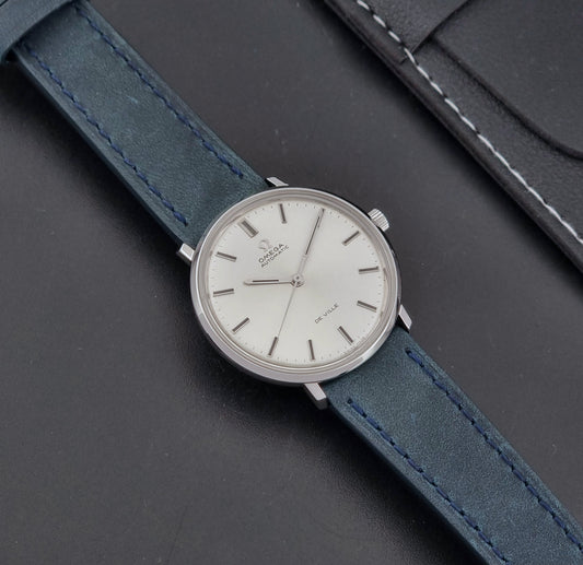 Vintage Omega Wristwatch De-Ville 165.033 with blue strap on a dark background dial 
