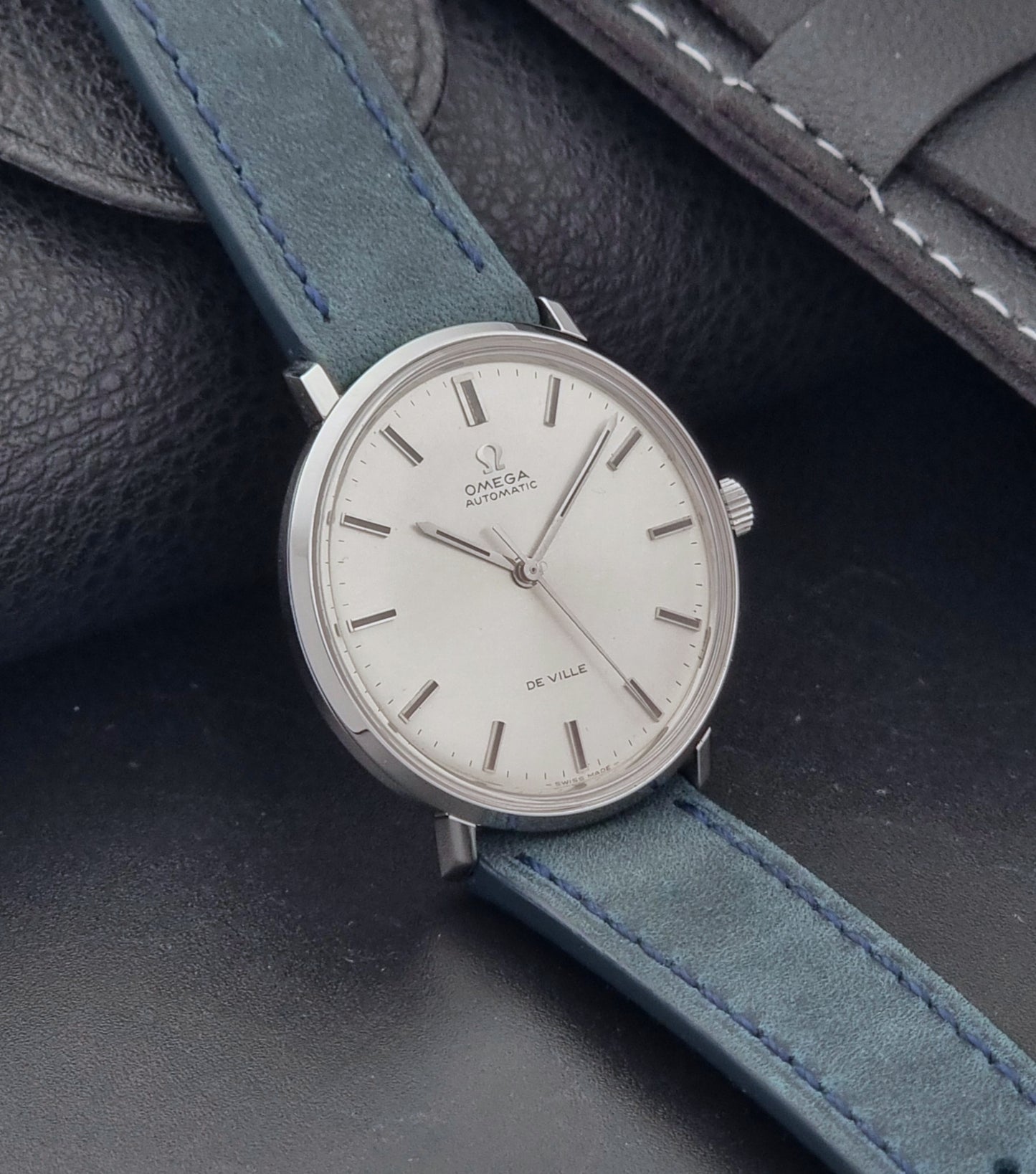 Vintage Omega Wristwatch De-Ville 165.033 with blue strap on a dark background side view