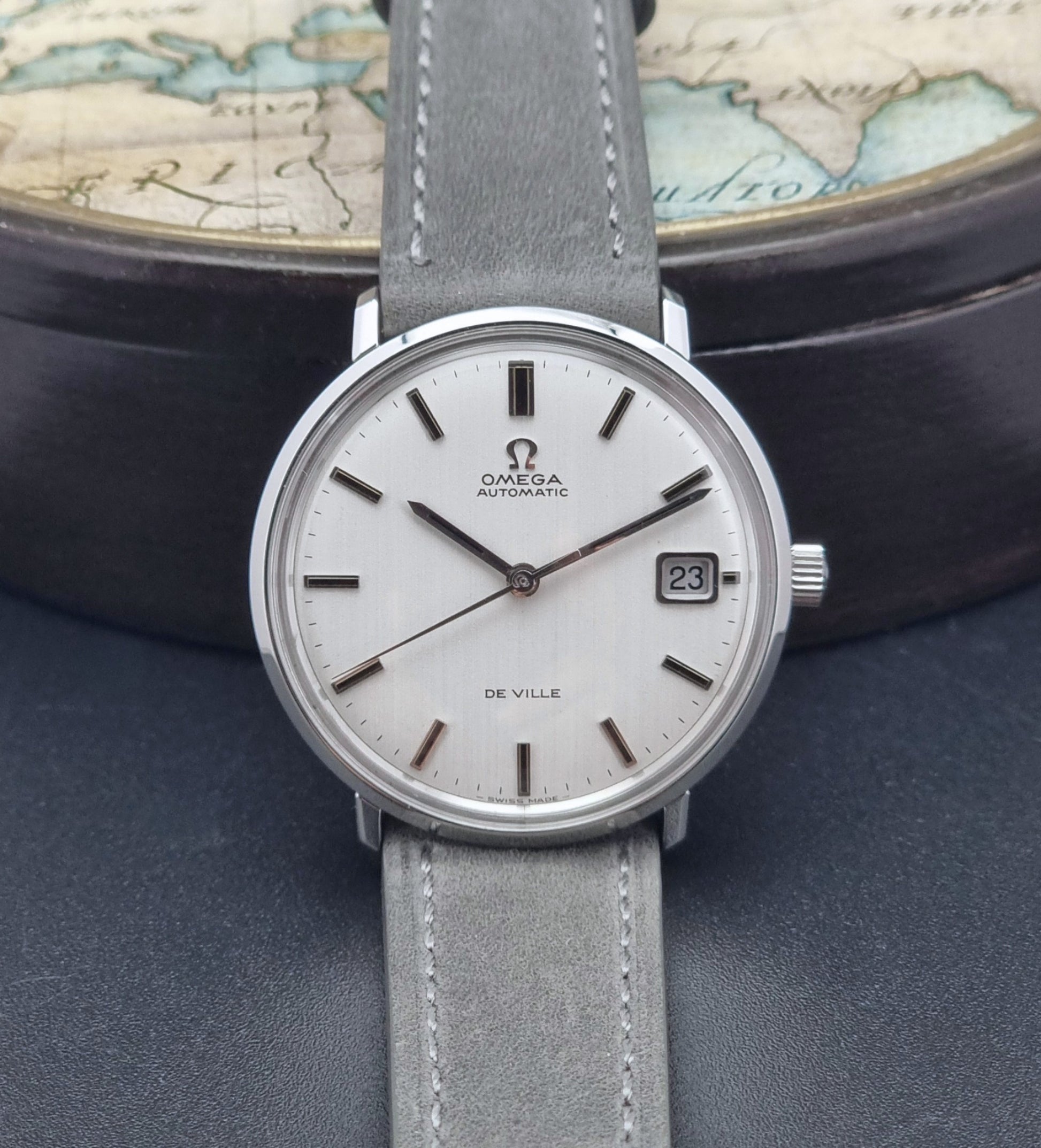 Vintage Omega Wristwatch De-Ville 166.033 with gray strap on a dark background front