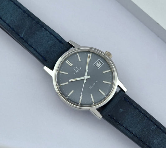Vintage Omega watch Geneve 136.0098 with dark blue leather strap on a light gray background dial