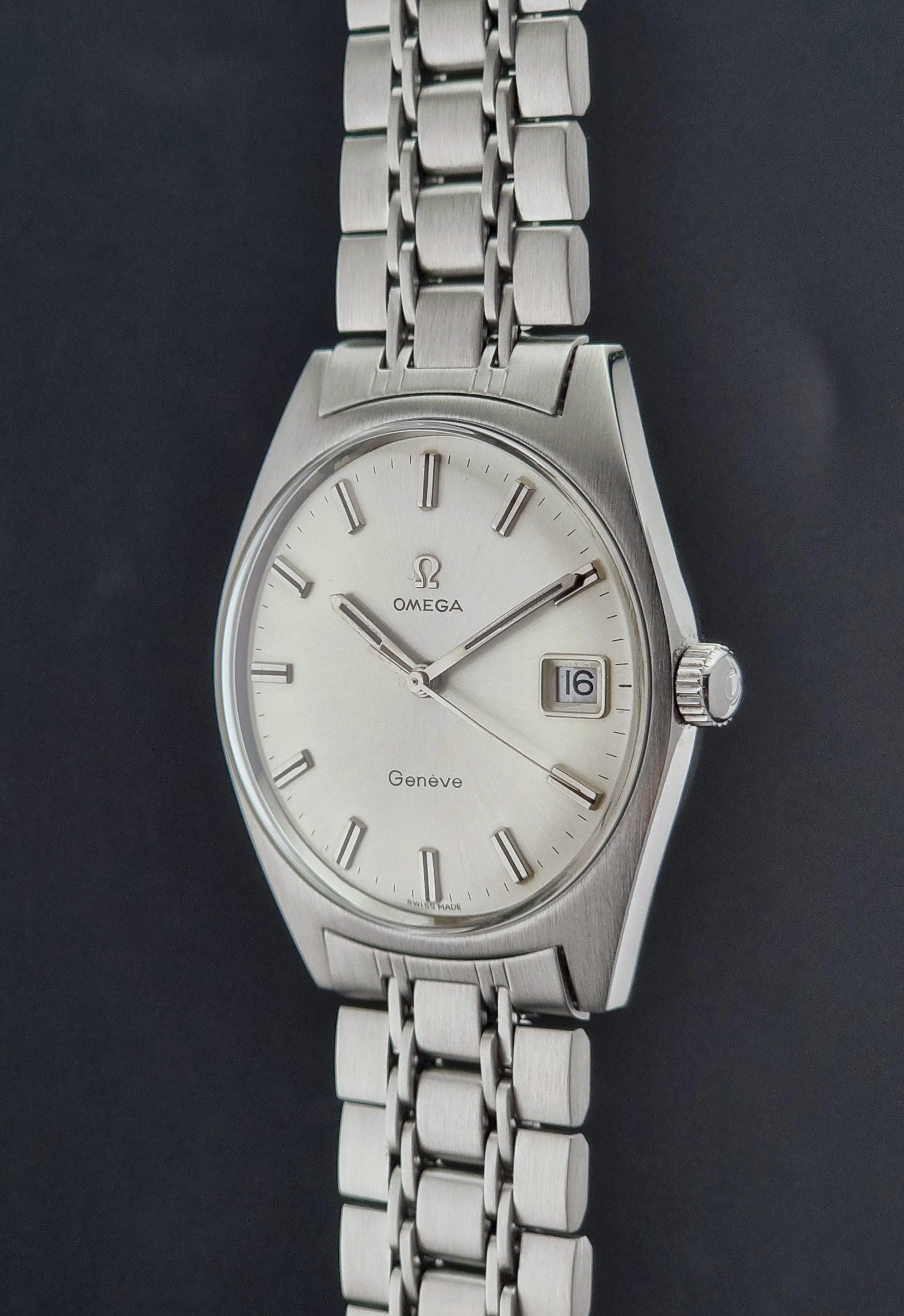 Silver Vintage Omega Geneve watch with a dark background