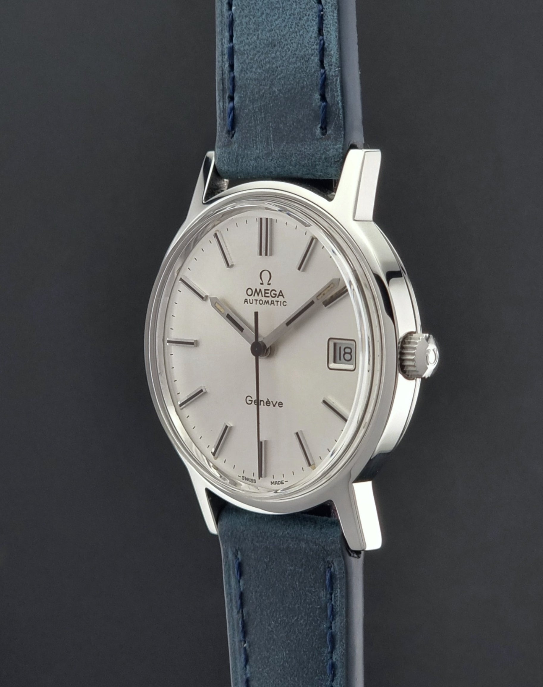 Vintage Omega Geneve 166.0163 wristwatch with blue strap on a dark background