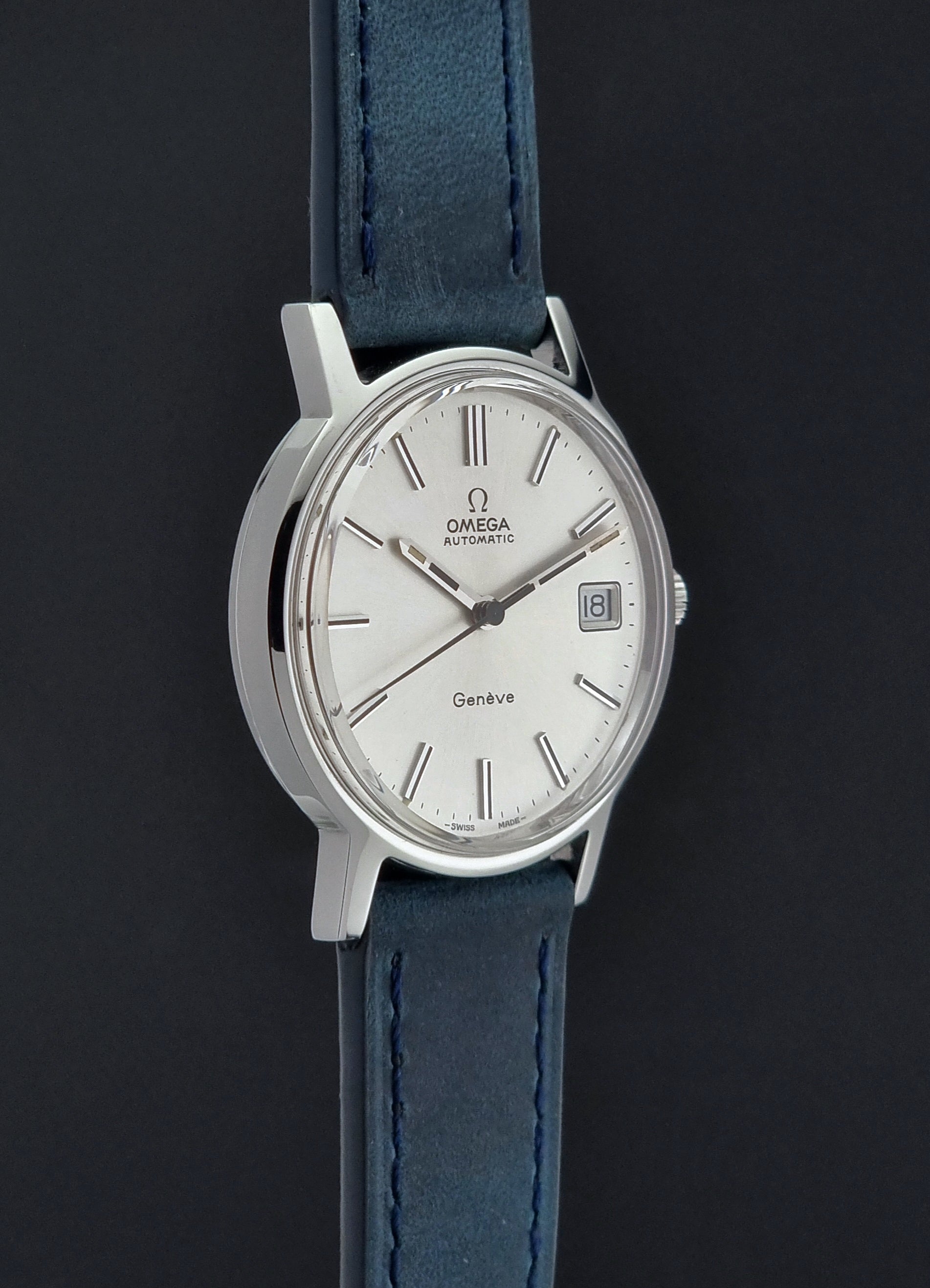 Vintage Omega Geneve 166.0163 wristwatch with blue strap on a dark background
