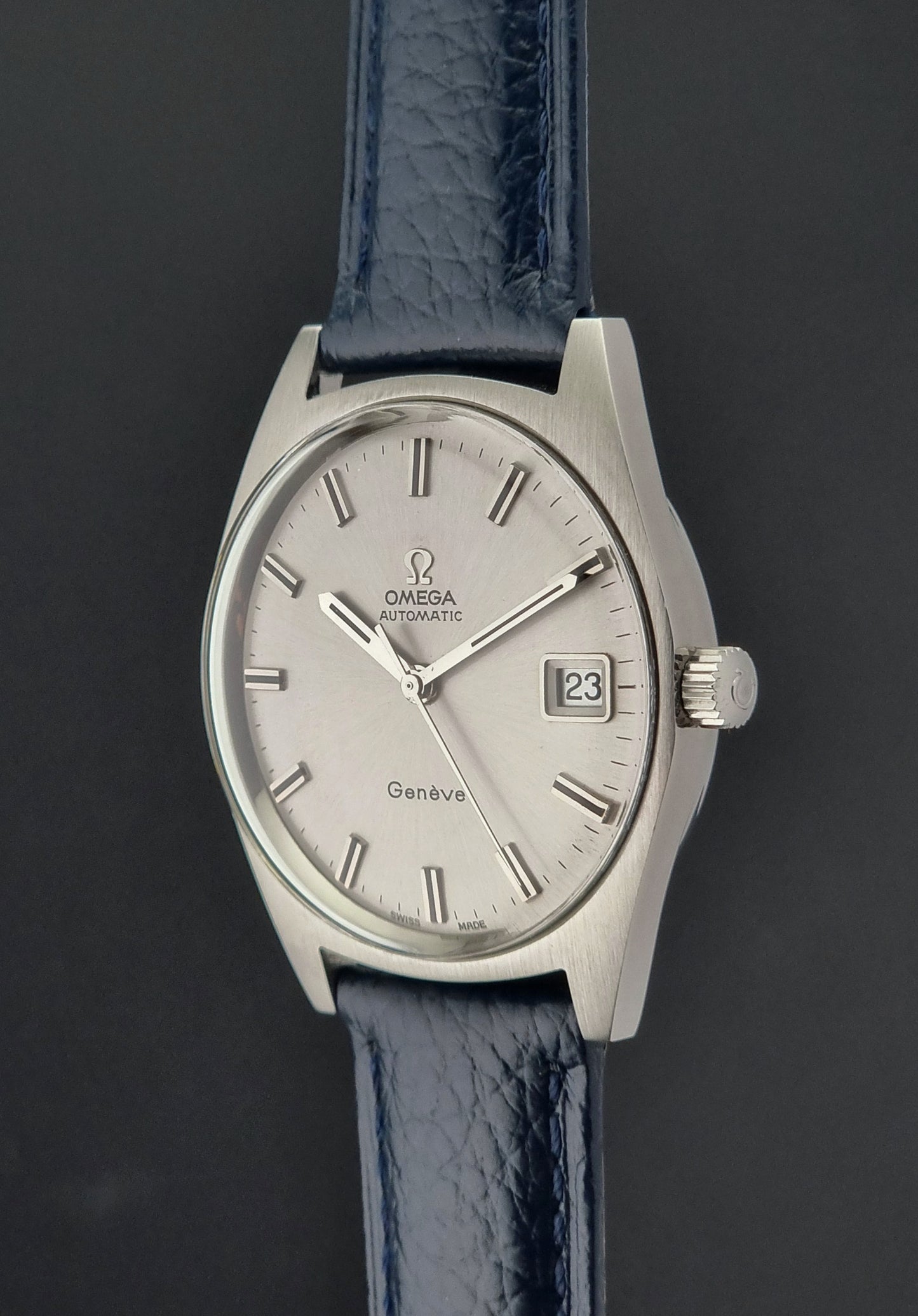 Omega watch with blue strap on a dark background