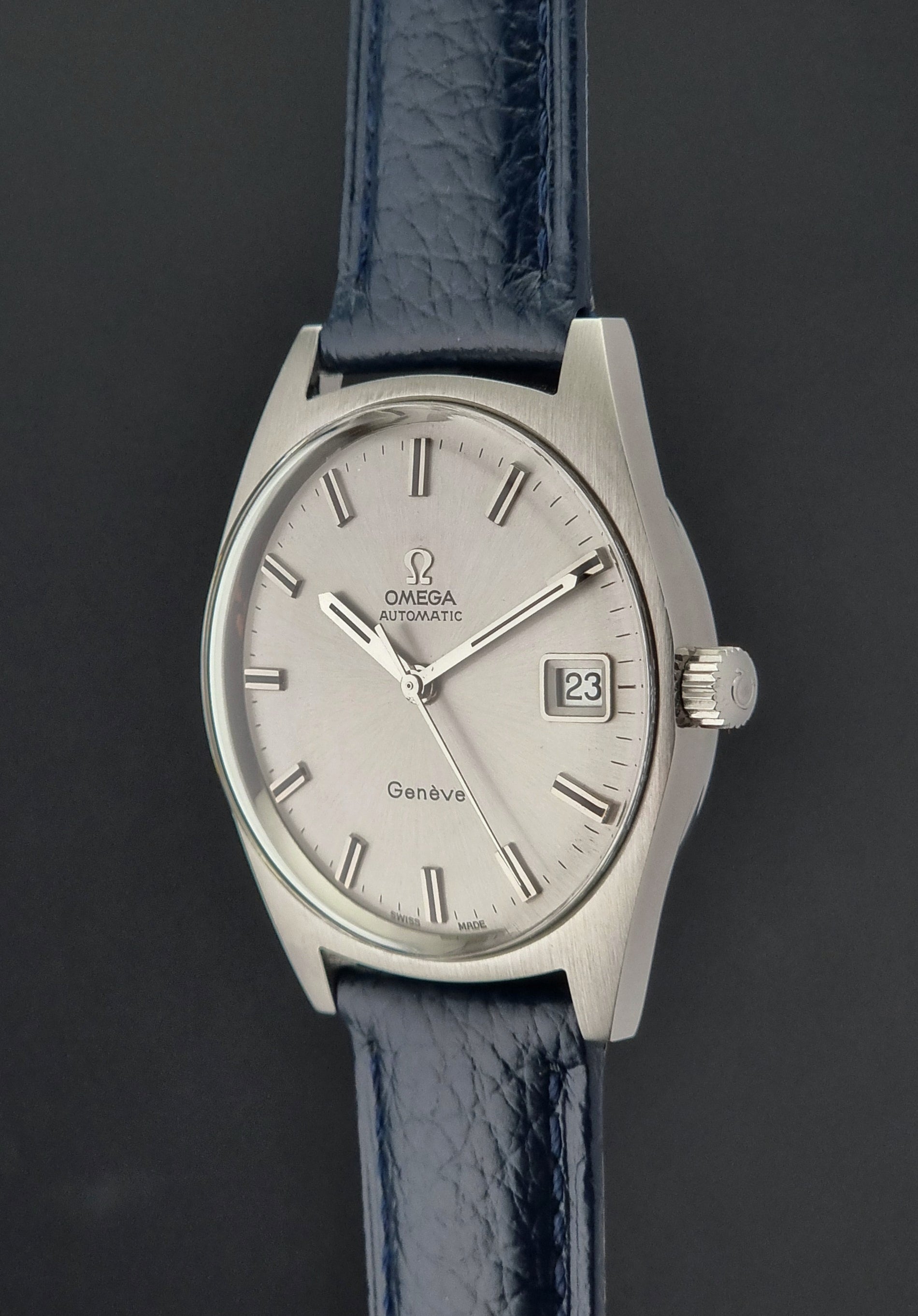 Omega watch with blue strap on a dark background