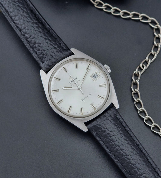 Vintage Omega watch Geneve 136.041 Co-signed Türler with a black leather strap and silver case on a dark background dial