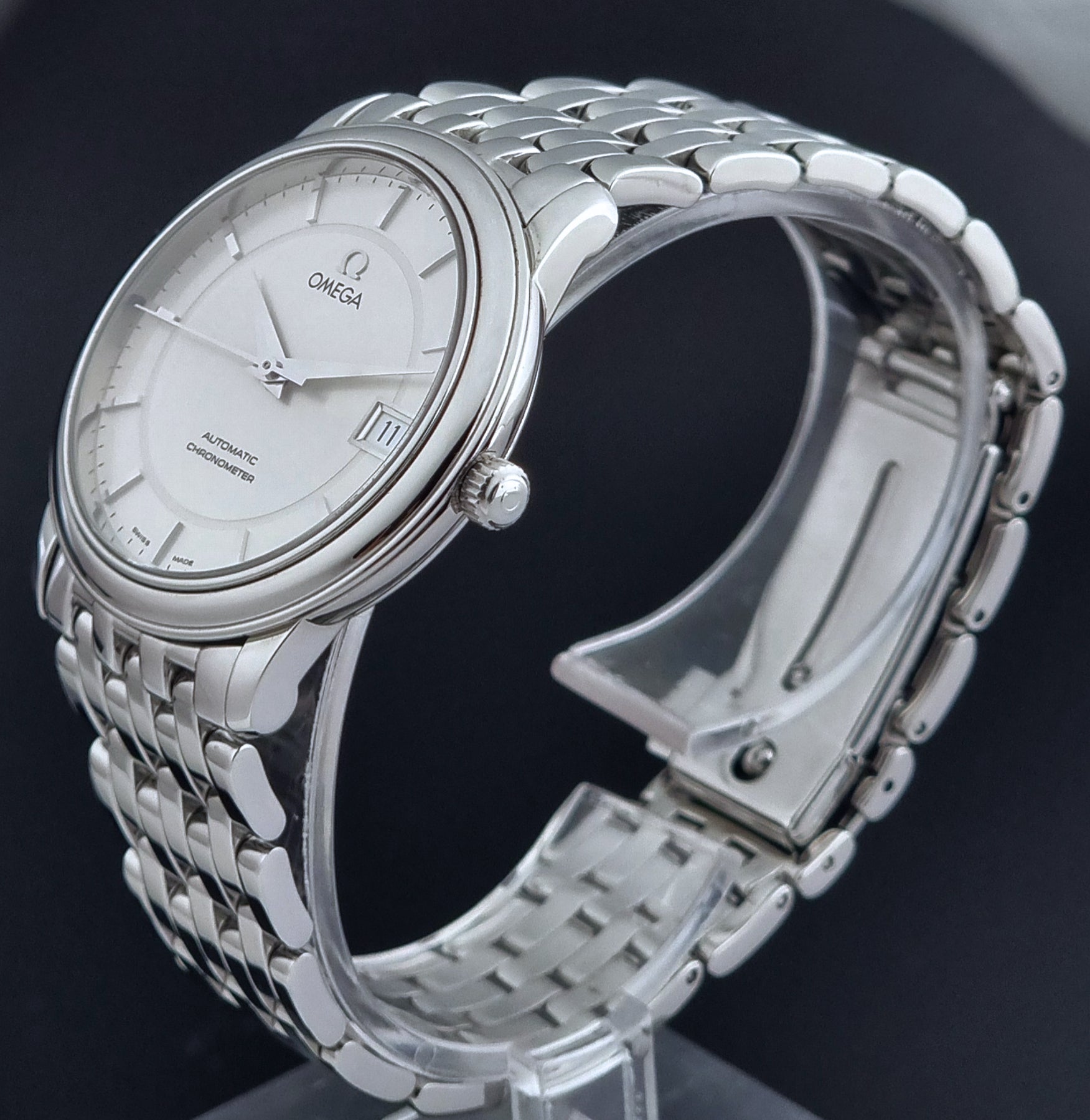 Omega watch a De-Ville Prestige 168.1050 with a stainless steel bracelet on a dark background crown profile view