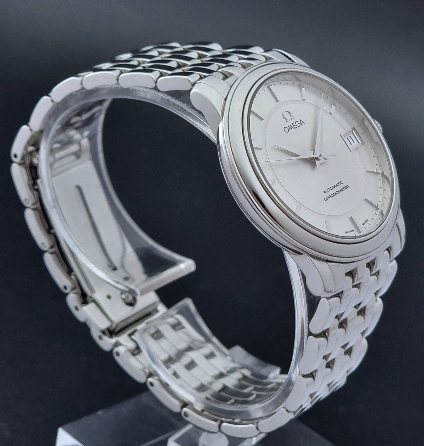 Omega watch a De-Ville Prestige 168.1050 with a stainless steel bracelet on a dark background side profile view