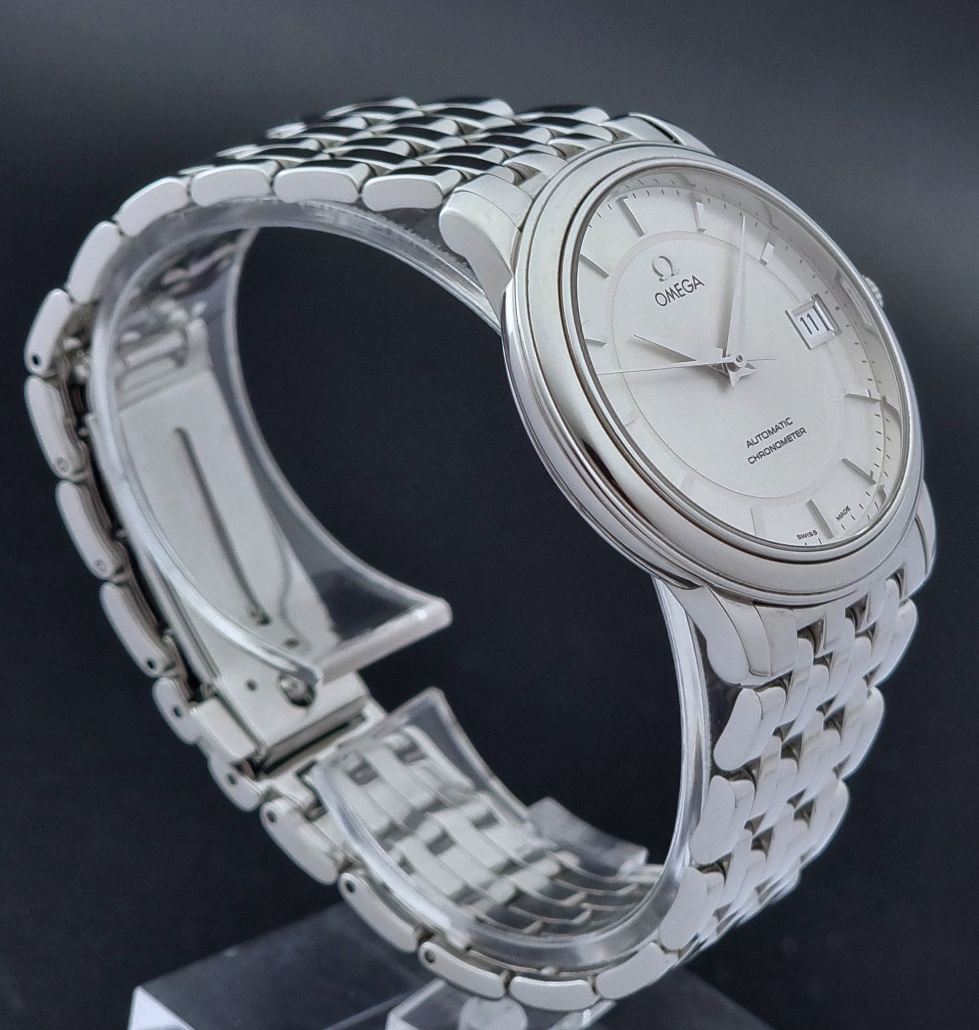 Omega watch a De-Ville Prestige 168.1050 with a stainless steel bracelet on a dark background side profile view