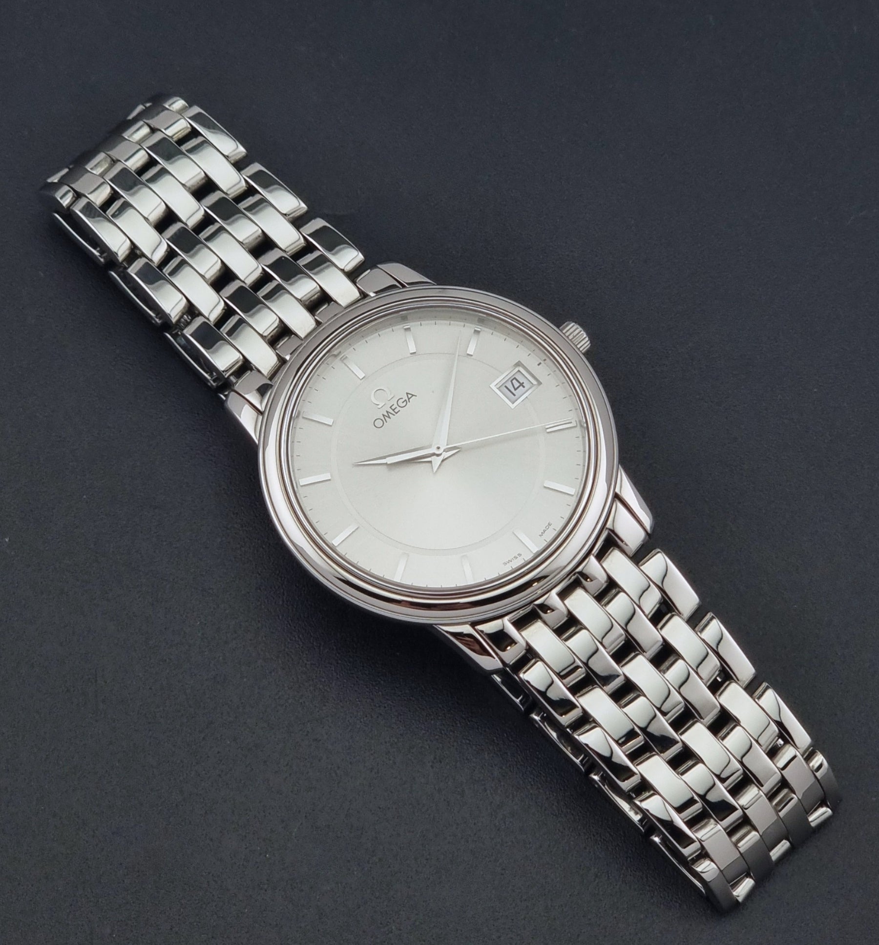 Omega De-Ville Prestige watch 196.1150 Quartz with its original stainless steel bracelet on a dark background dial
