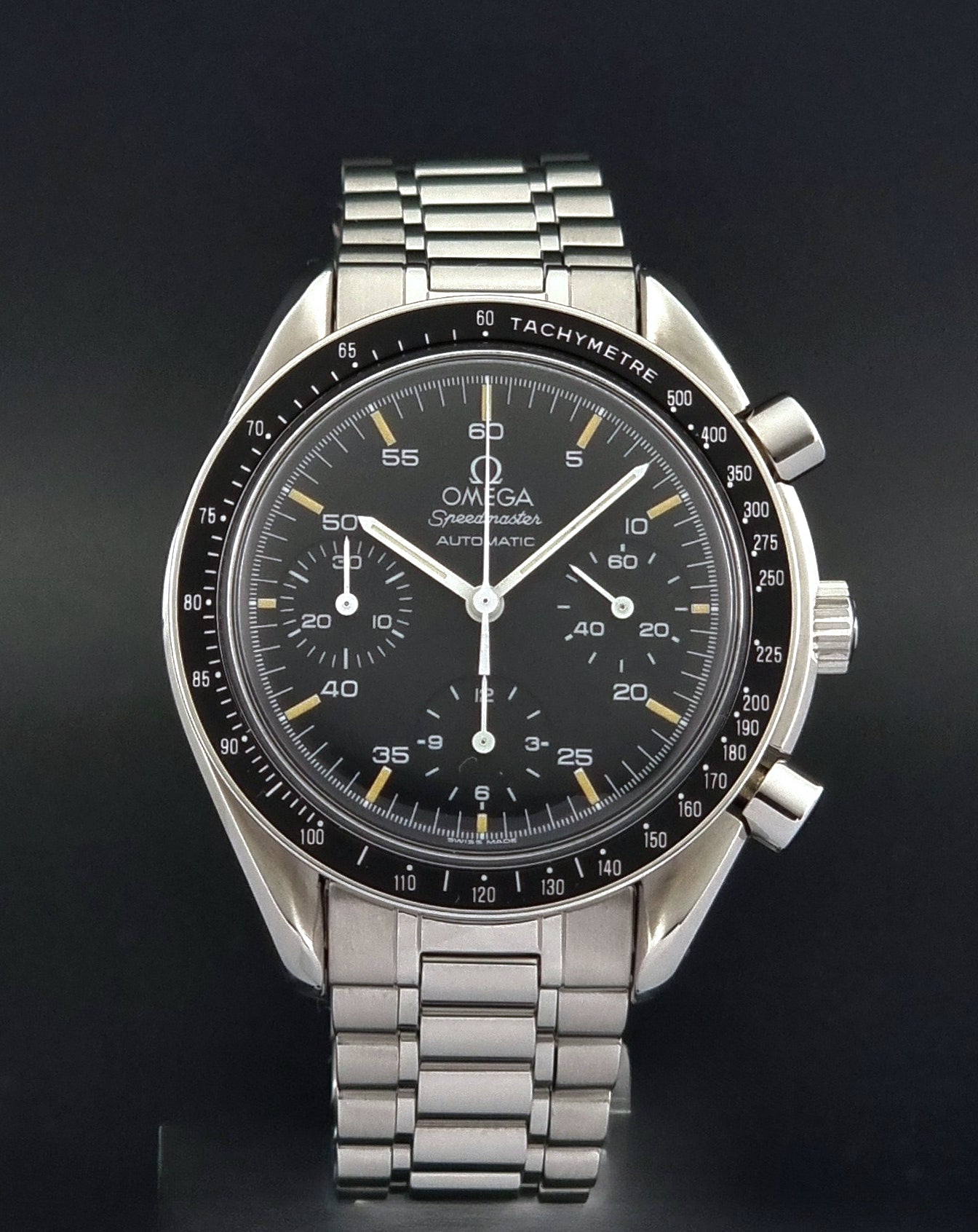 Vintage Omega watch Speedmaster Reduced 3510.50 watch with a black dial on a dark textured background close front view