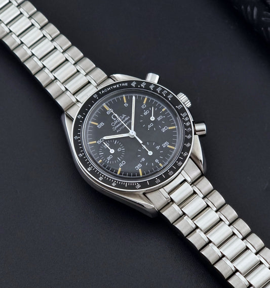 Vintage Omega watch Speedmaster Reduced 3510.50 watch with a black dial on a dark textured background dial