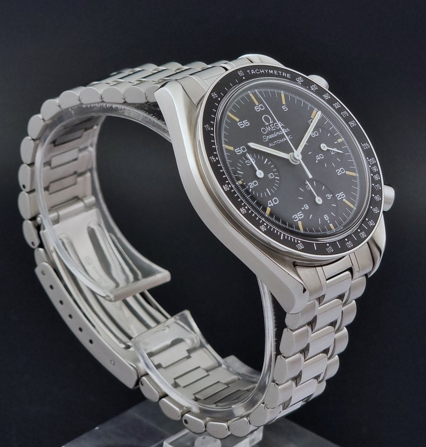 Vintage Omega watch Speedmaster Reduced 3510.50 watch with a black dial on a dark textured background close side view