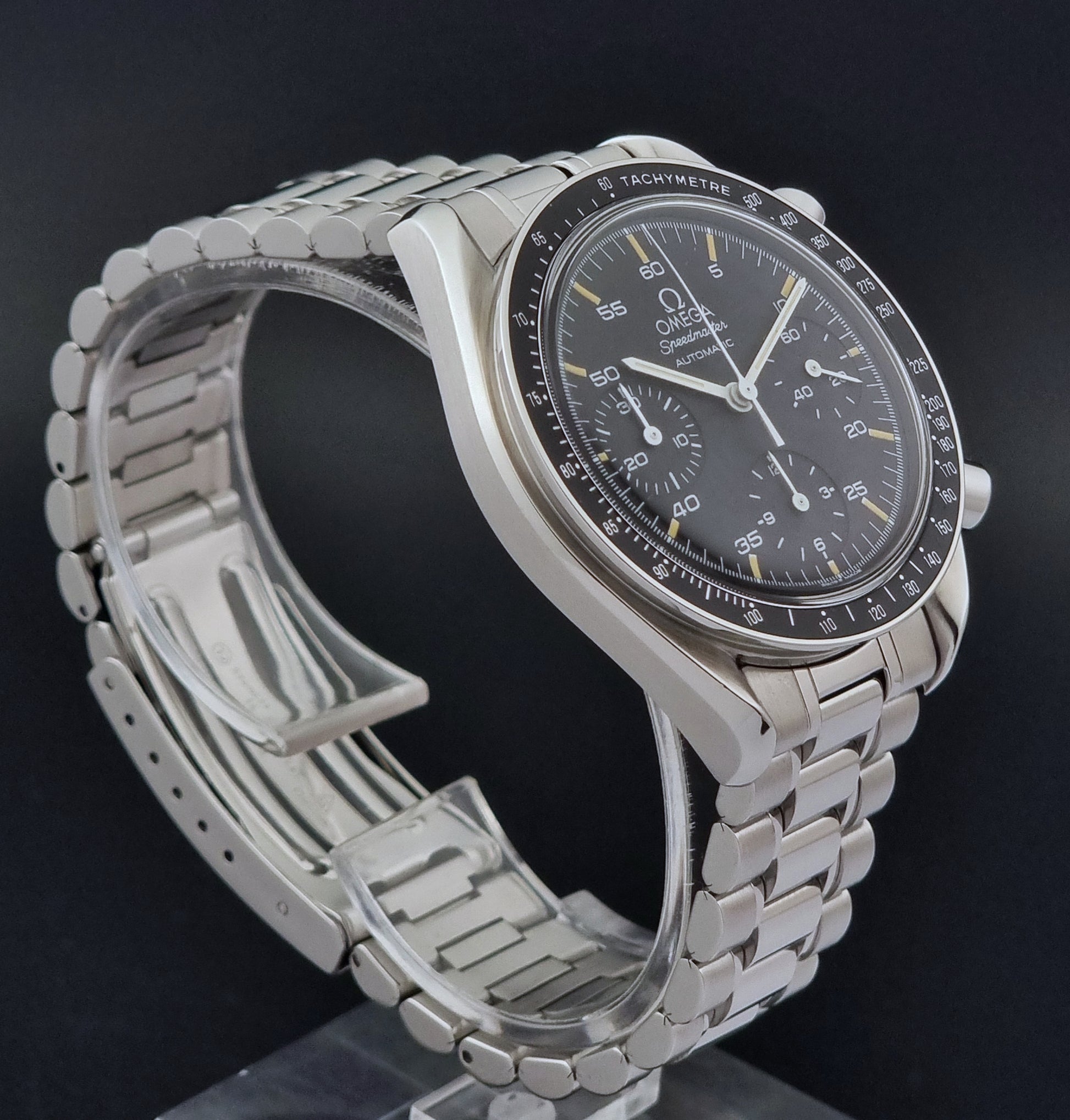 Vintage Omega watch Speedmaster Reduced 3510.50 watch with a black dial on a dark textured background close side view