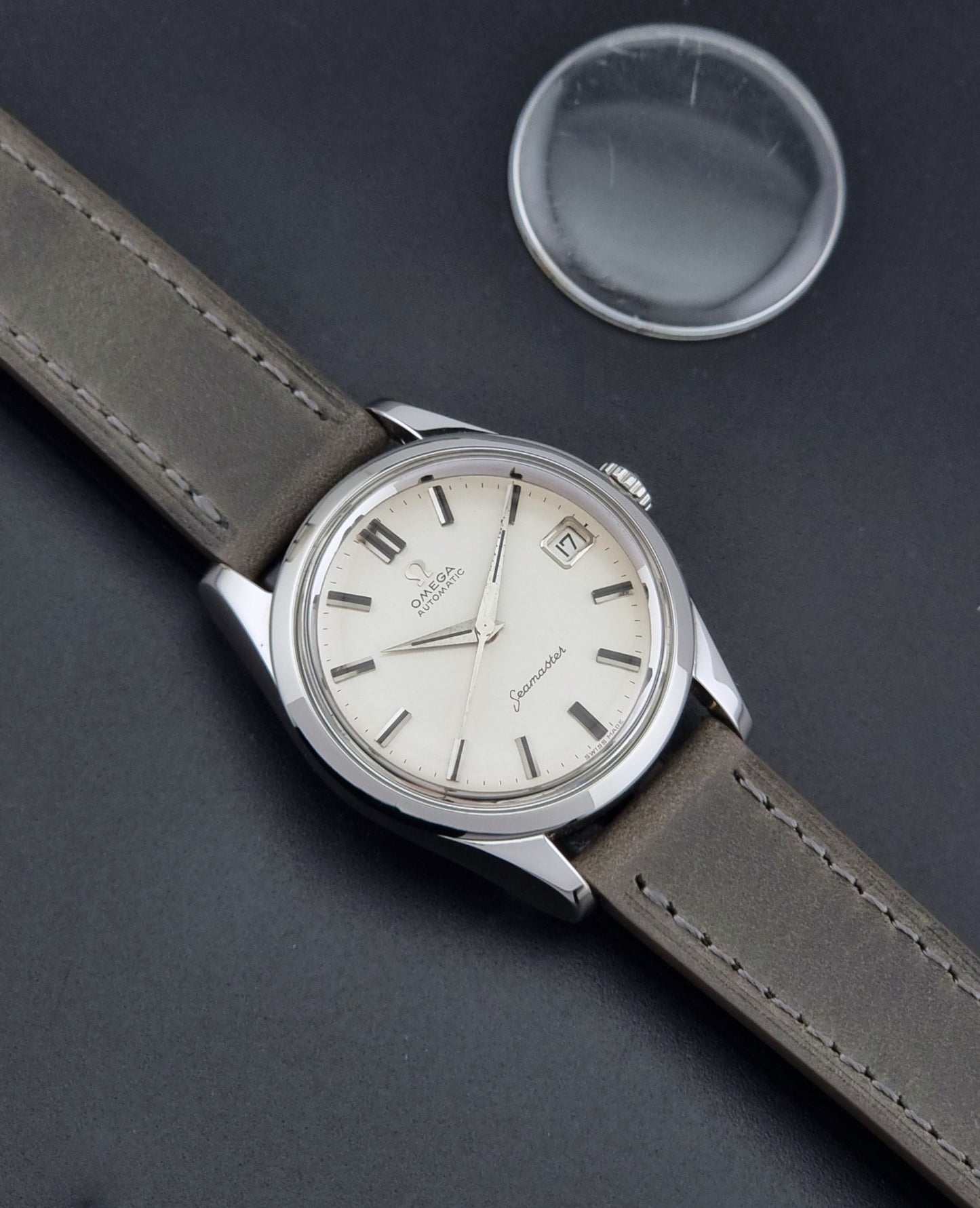 Vintage Omega Seamaster 14763 with a grey leather strap on a dark background dial 