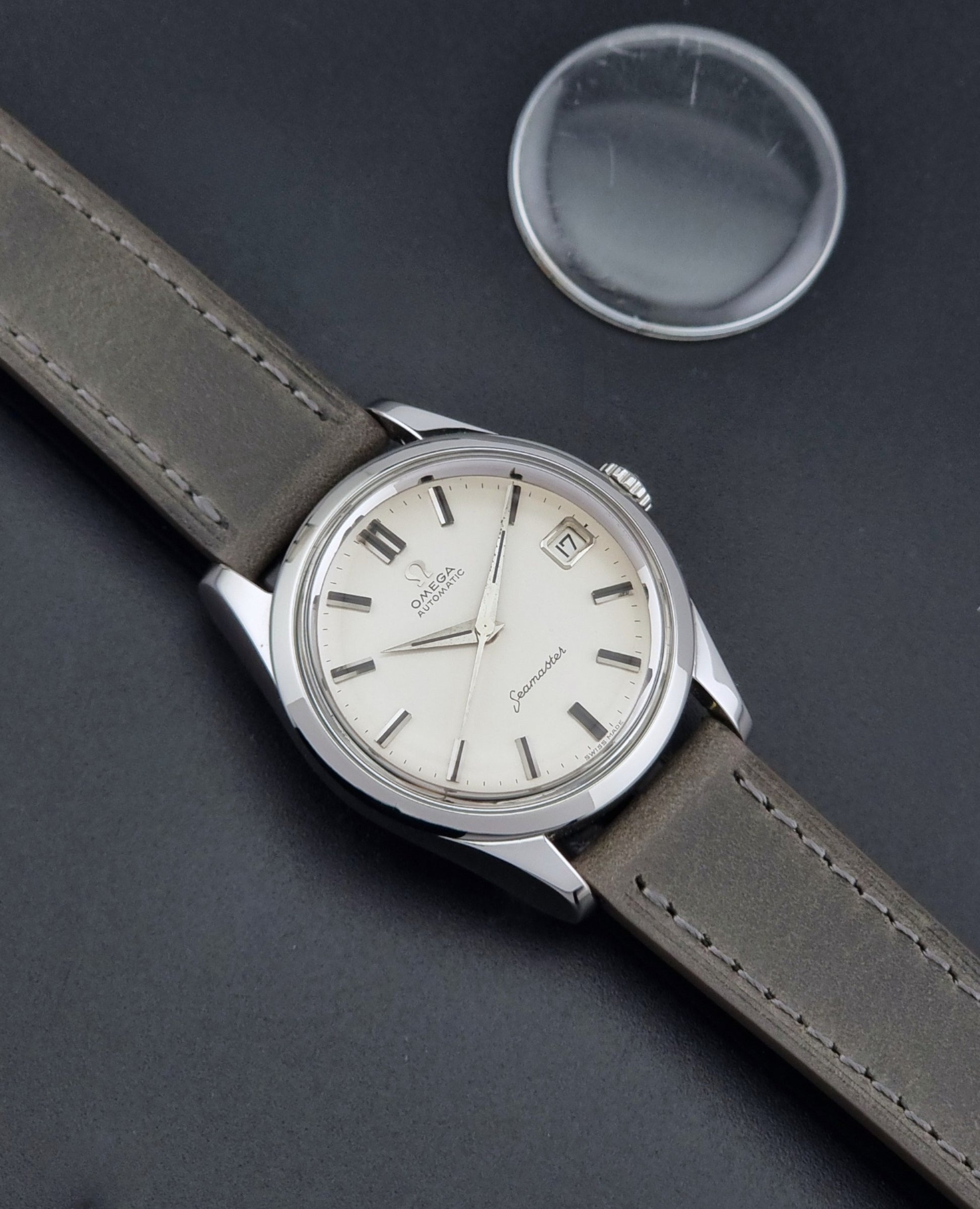 Vintage Omega Seamaster 14763 with a grey leather strap on a dark background dial 