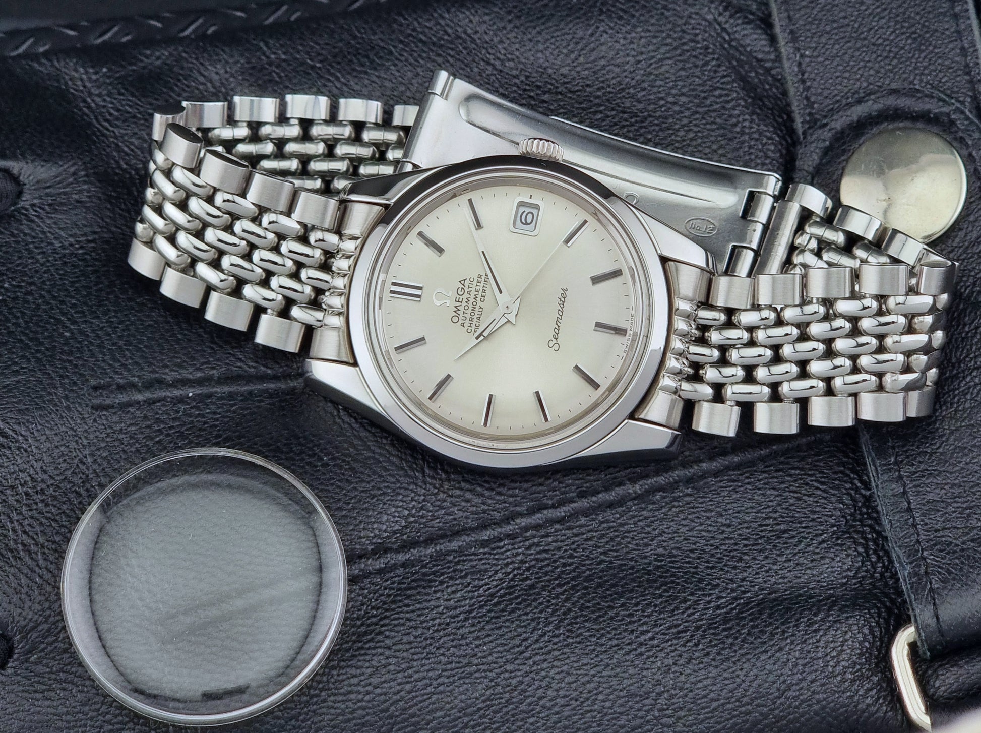 Vintage Omega Wristwatch Seamaster 166.010 Chronometer with stainless steel bracelet on a dark background original crystal