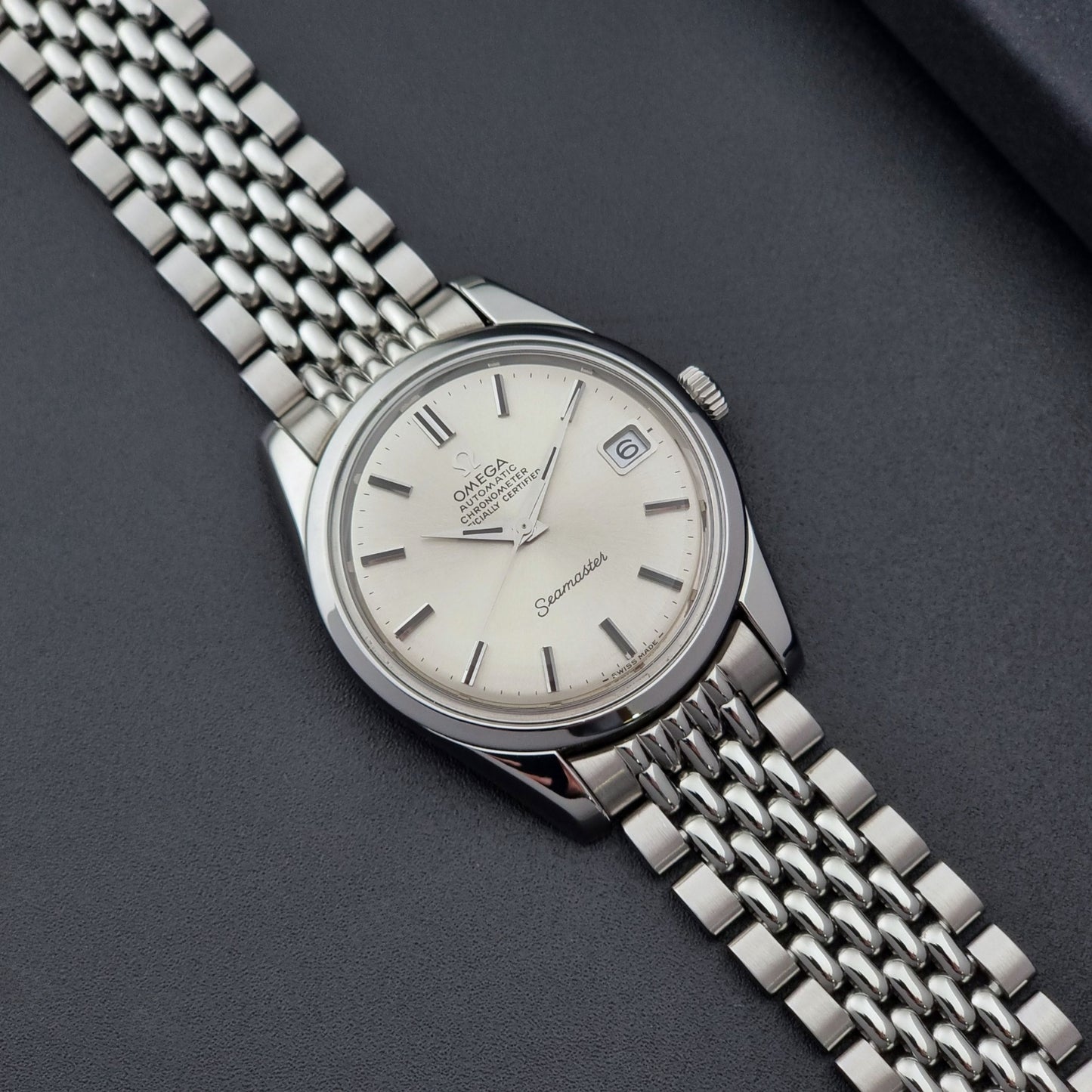 Vintage Omega Wristwatch Seamaster 166.010 Chronometer with stainless steel bracelet on a dark background
