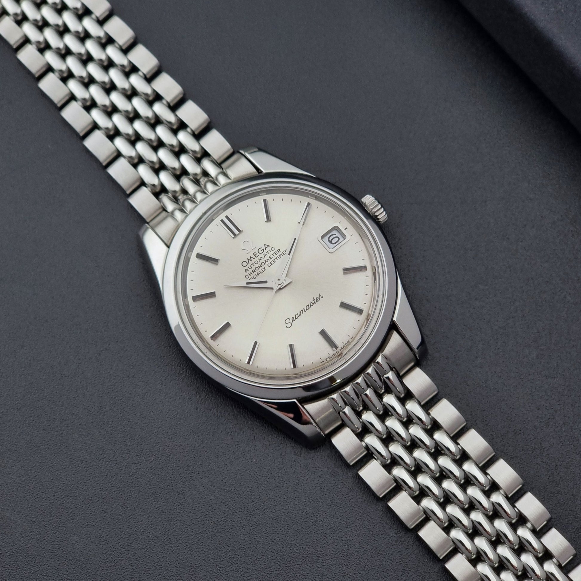 Vintage Omega Wristwatch Seamaster 166.010 Chronometer with stainless steel bracelet on a dark background