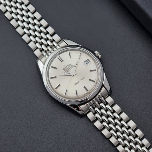 Vintage Omega Wristwatch Seamaster 166.010 Chronometer with stainless steel bracelet on a dark background