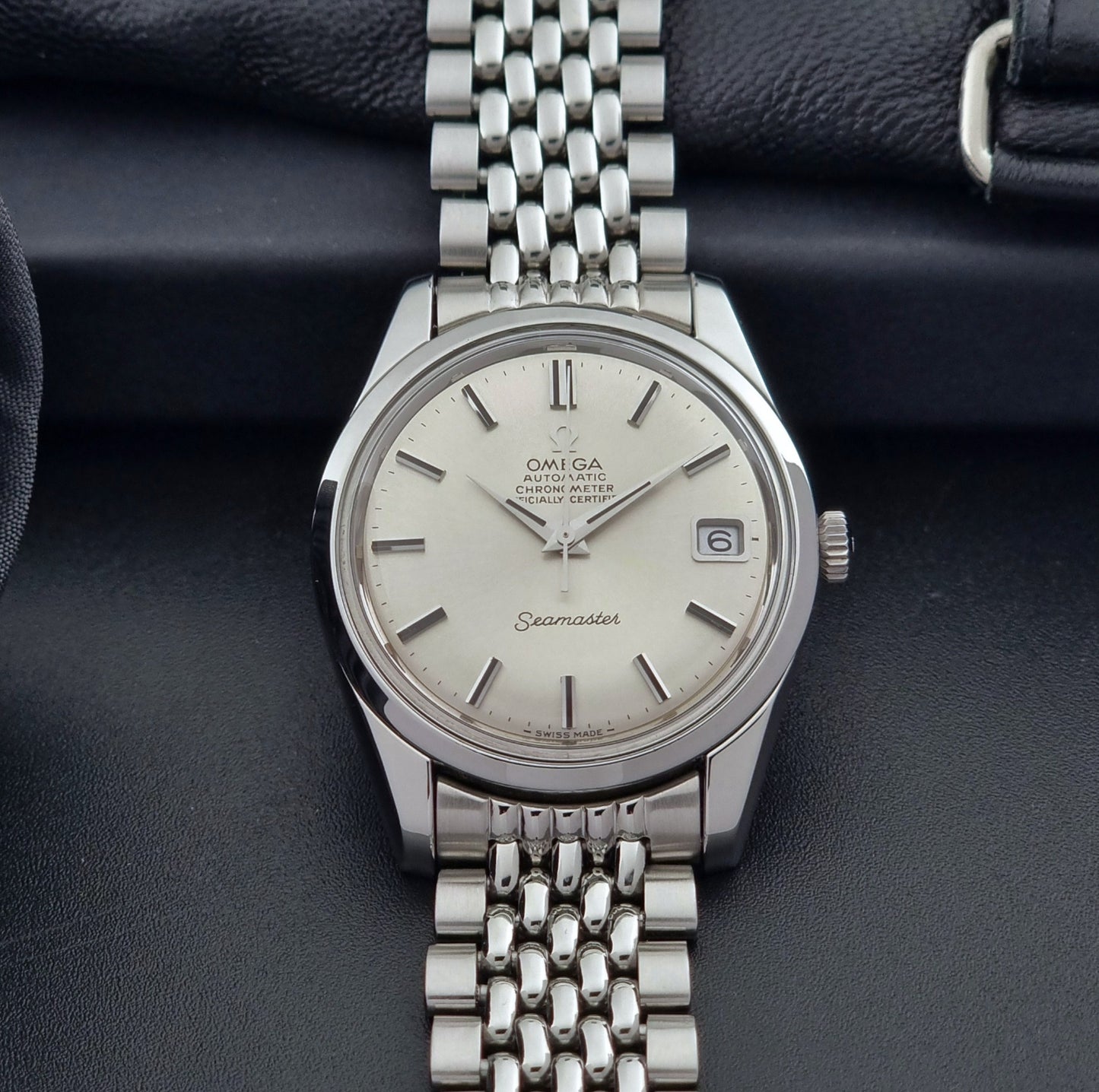 Vintage Omega Wristwatch Seamaster 166.010 Chronometer with stainless steel bracelet on a dark background front