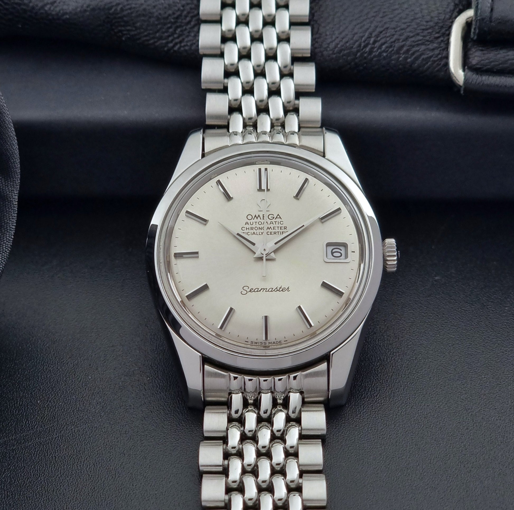 Vintage Omega Wristwatch Seamaster 166.010 Chronometer with stainless steel bracelet on a dark background front