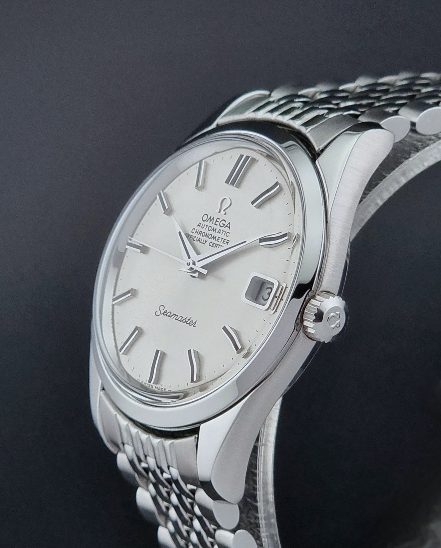 Vintage Omega Wristwatch Seamaster 166.010 watch on a dark gray background crown view