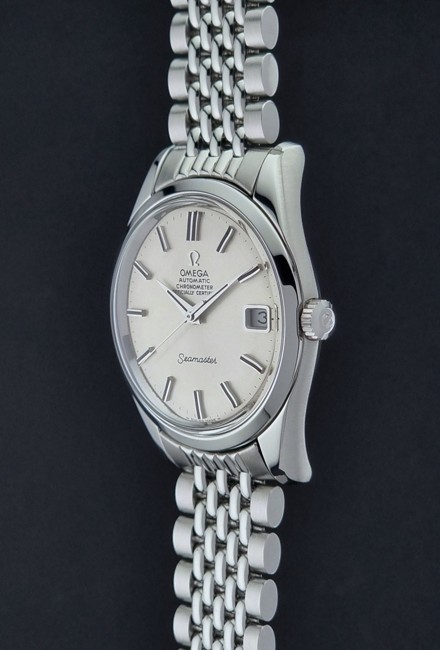 Vintage Omega Wristwatch Seamaster 166.010 watch on a dark gray background crown profile view