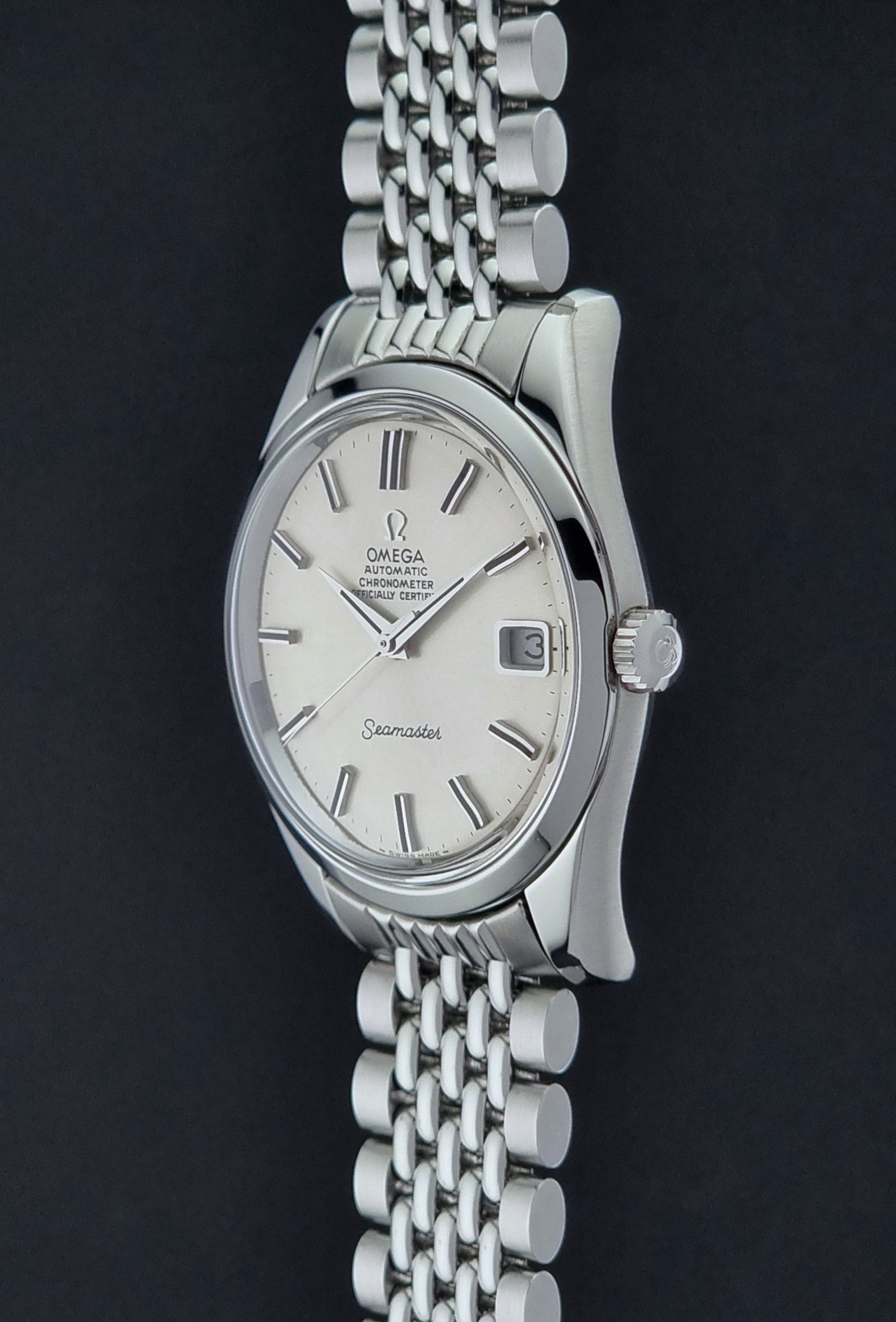 Vintage Omega Wristwatch Seamaster 166.010 watch on a dark gray background crown profile view