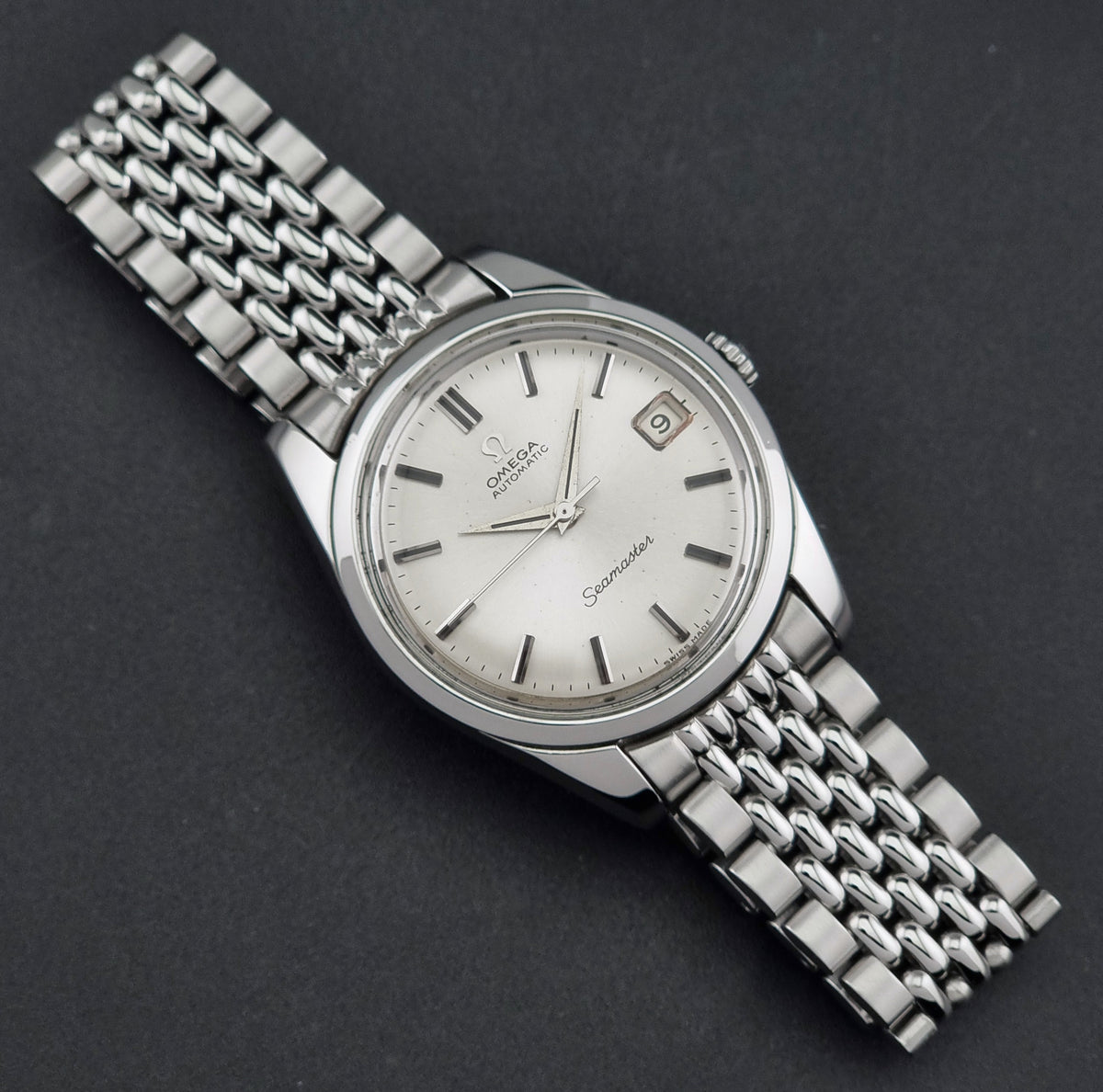1966 vintage Omega Seamaster 166.010 automatic watch, front view highlighting the silver sunburst dial