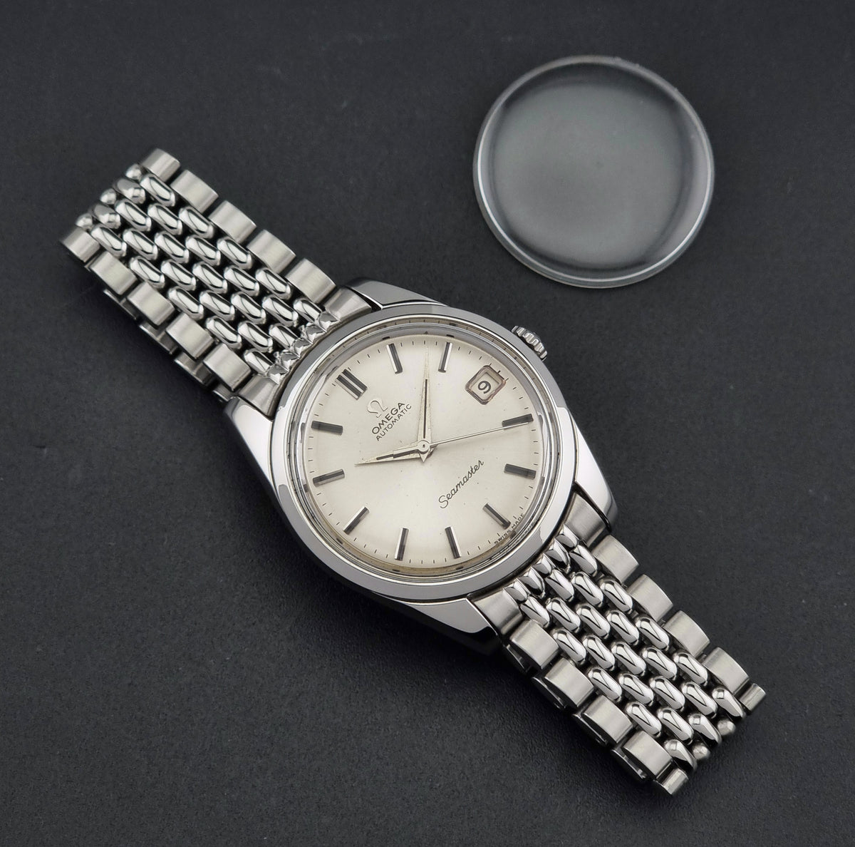 1966 vintage Omega Seamaster 166.010 automatic watch, front view featuring the silver sunburst dial