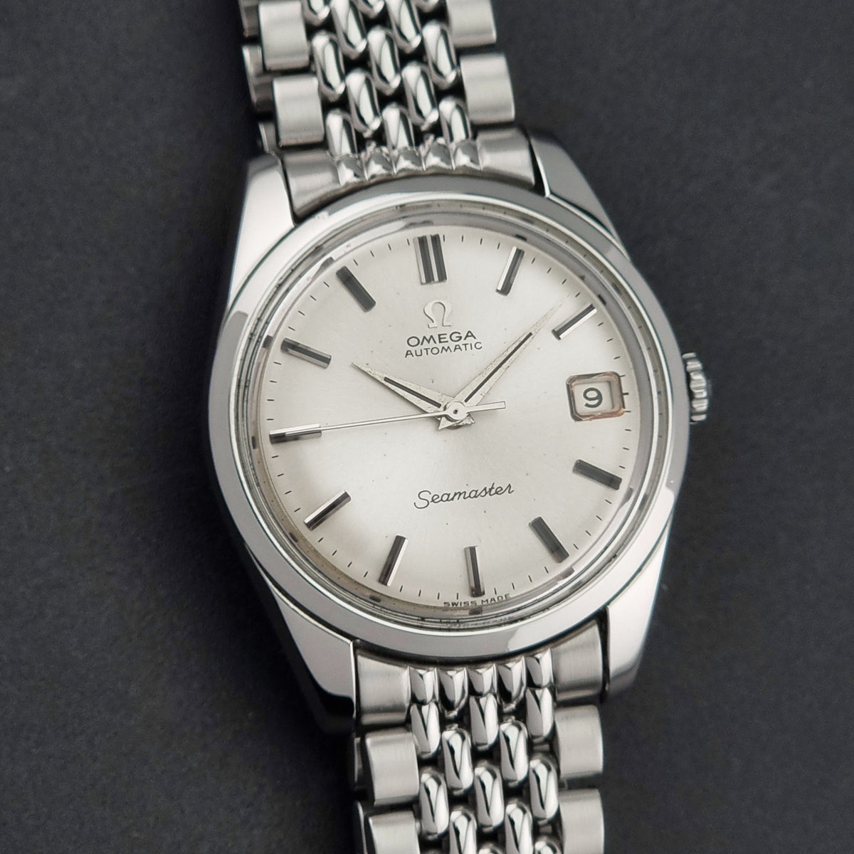 1966 vintage Omega Seamaster 166.010 automatic watch, additional face-on view of the silver sunburst dial and hands