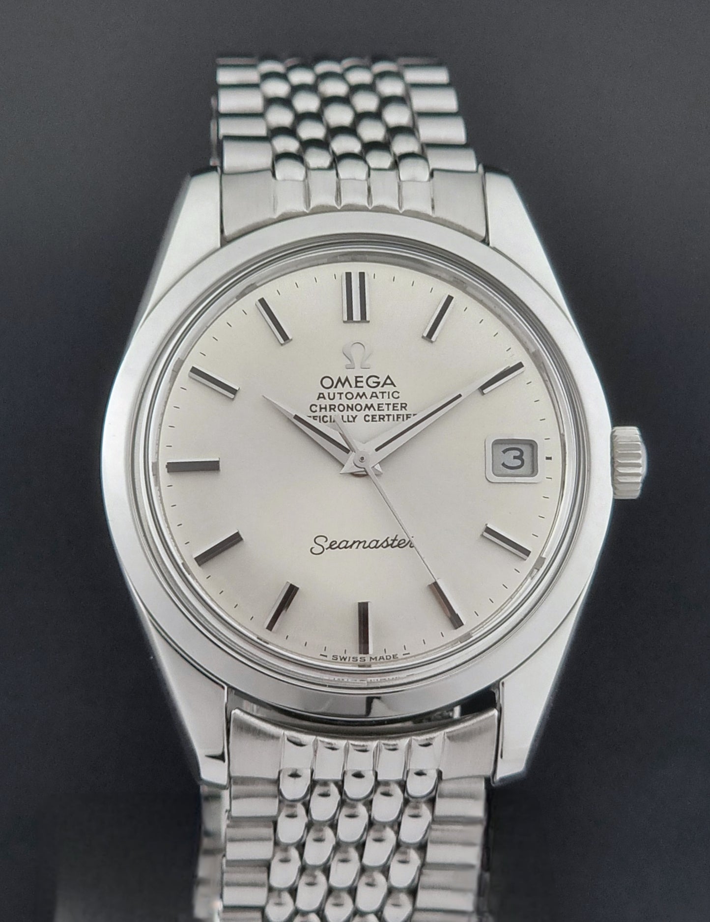 Vintage Omega Wristwatch Seamaster 166.010 watch on a dark gray background close up dial view