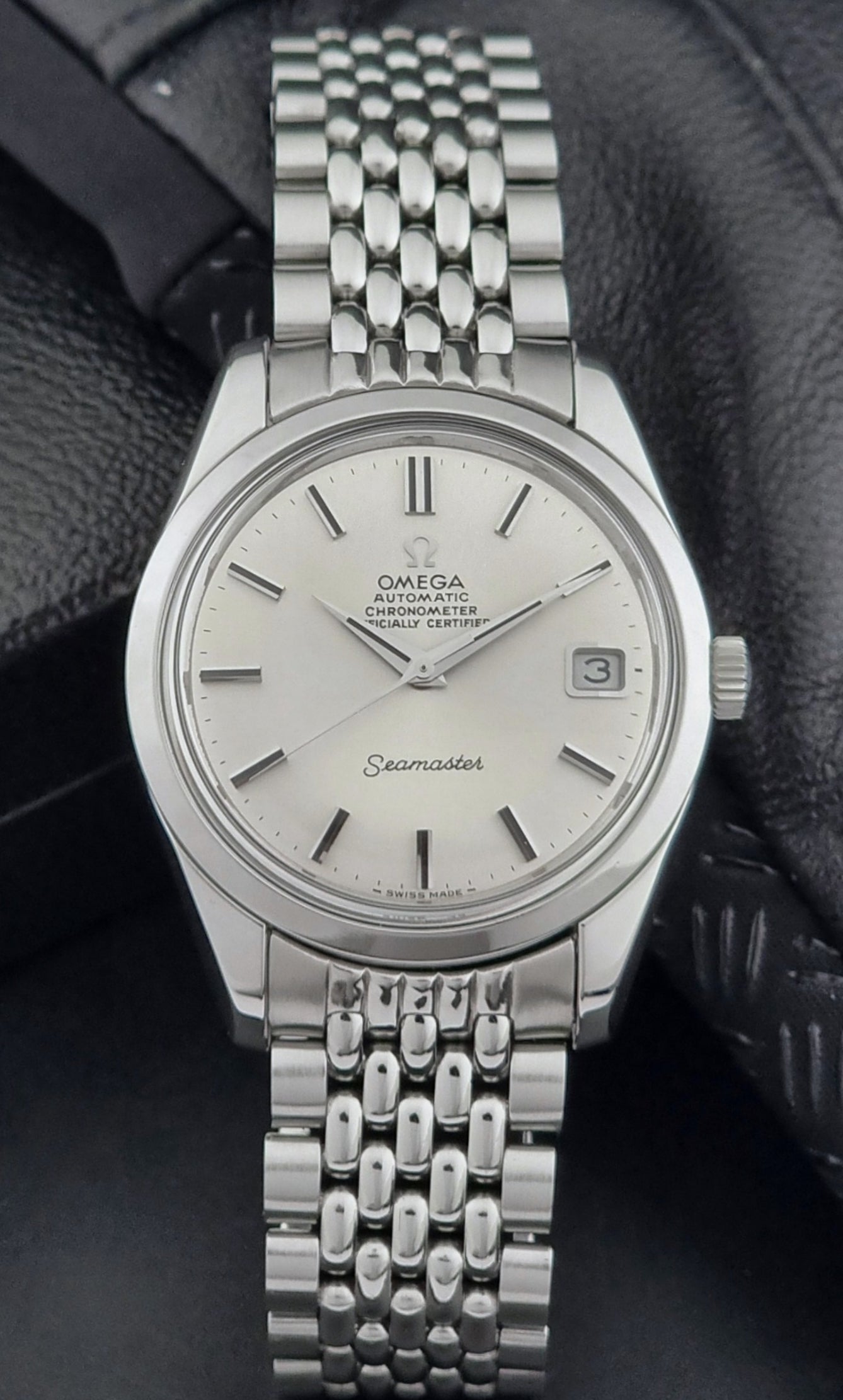 Vintage Omega Wristwatch Seamaster 166.010 watch on a dark gray background dial view
