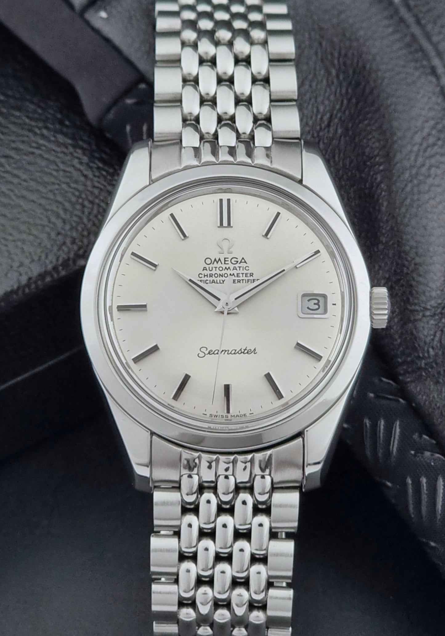 Vintage Omega Wristwatch Seamaster 166.010 watch on a dark gray background front view