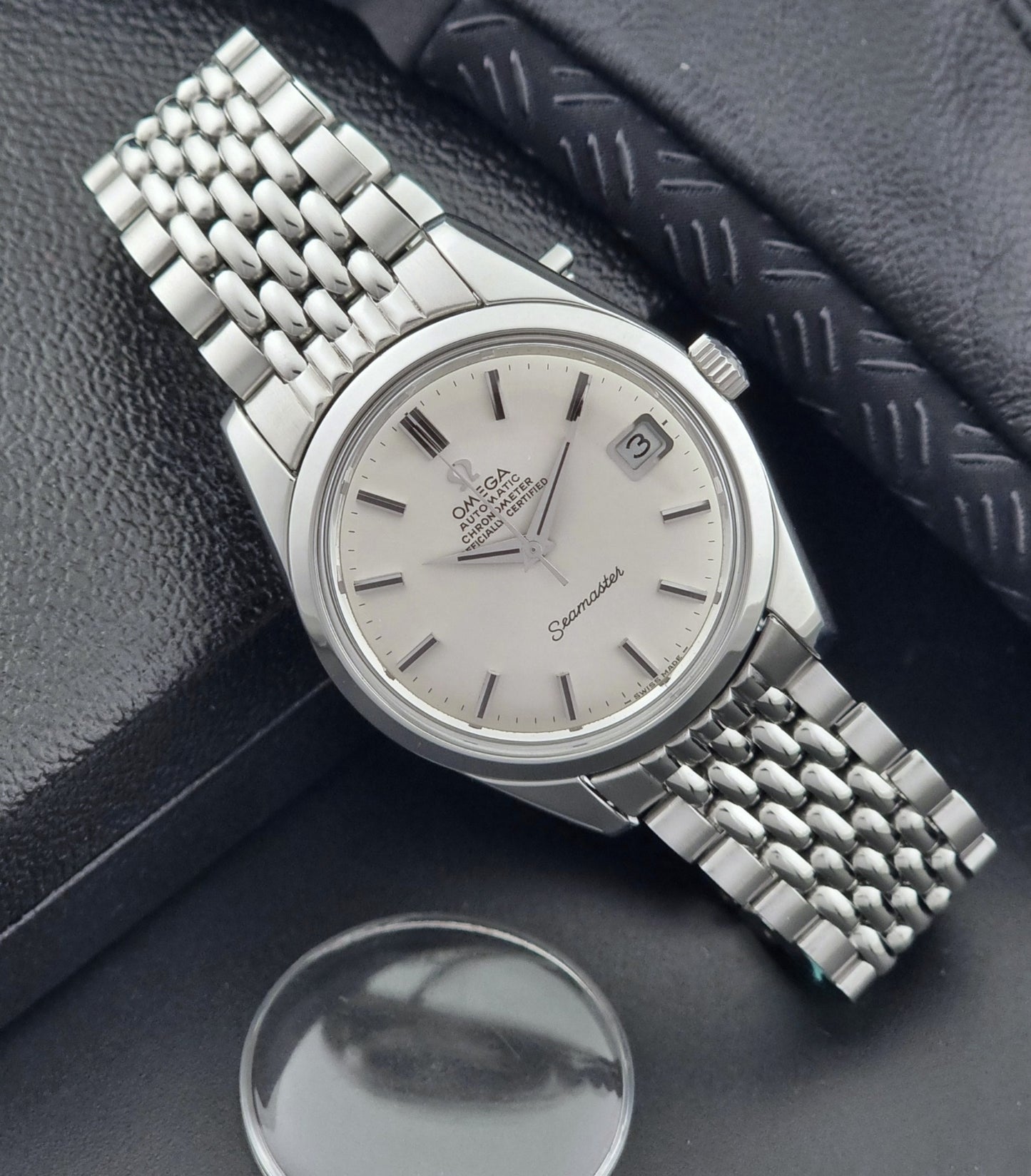 Vintage Omega Wristwatch Seamaster 166.010 watch on a dark gray background crystal view