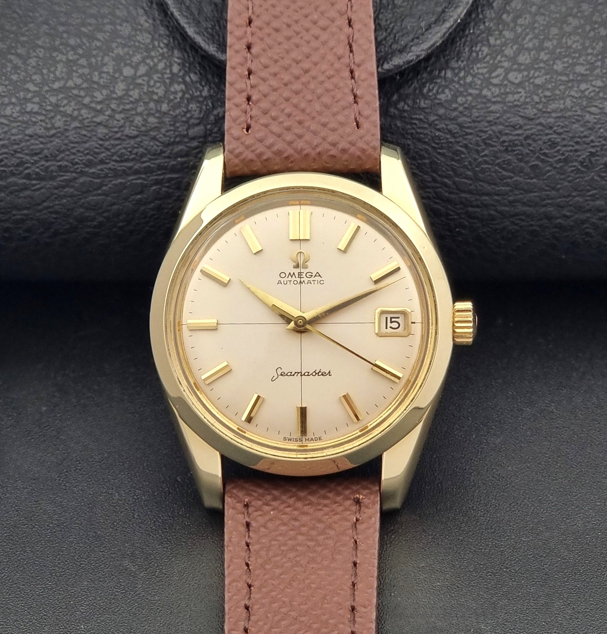 Vintage Omega Wristwatch Seamaster 14763  with a brown leather strap on a dark textured background dial view