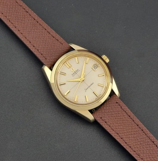 Vintage Omega Wristwatch Seamaster 14763  with a brown leather strap on a dark textured background dial