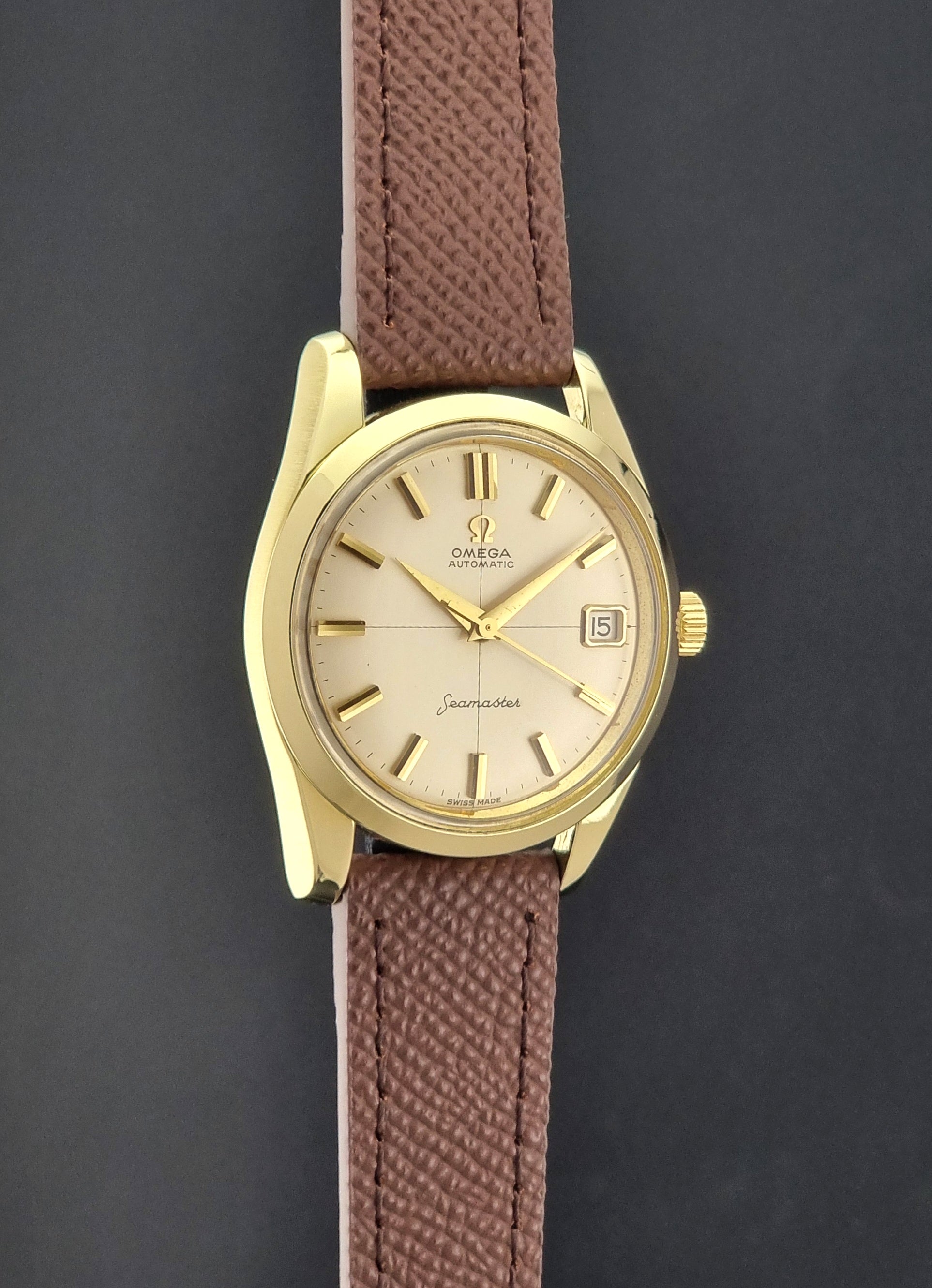 Vintage Omega Wristwatch Seamaster 14763  with a brown leather strap on a dark textured background side profie view