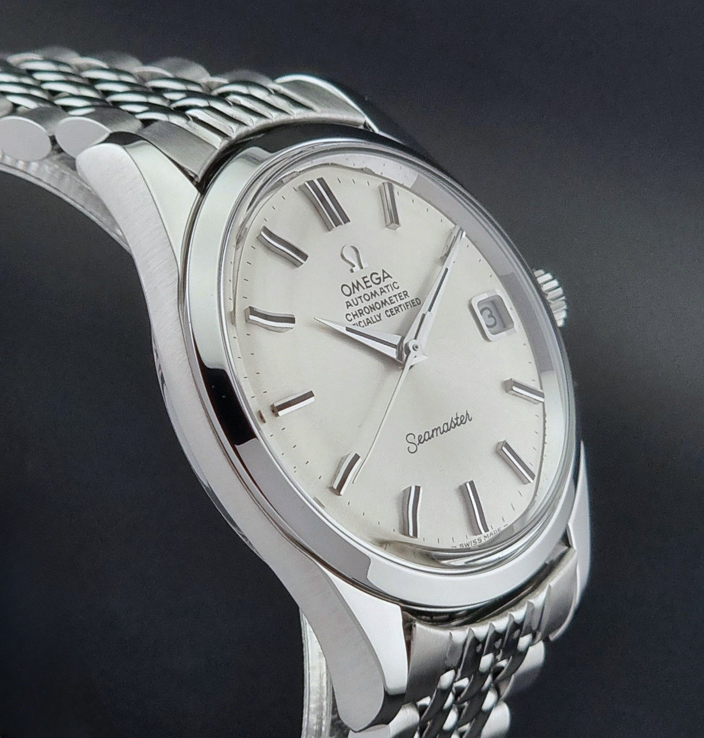 Vintage Omega Wristwatch Seamaster 166.010 watch on a dark gray background side view