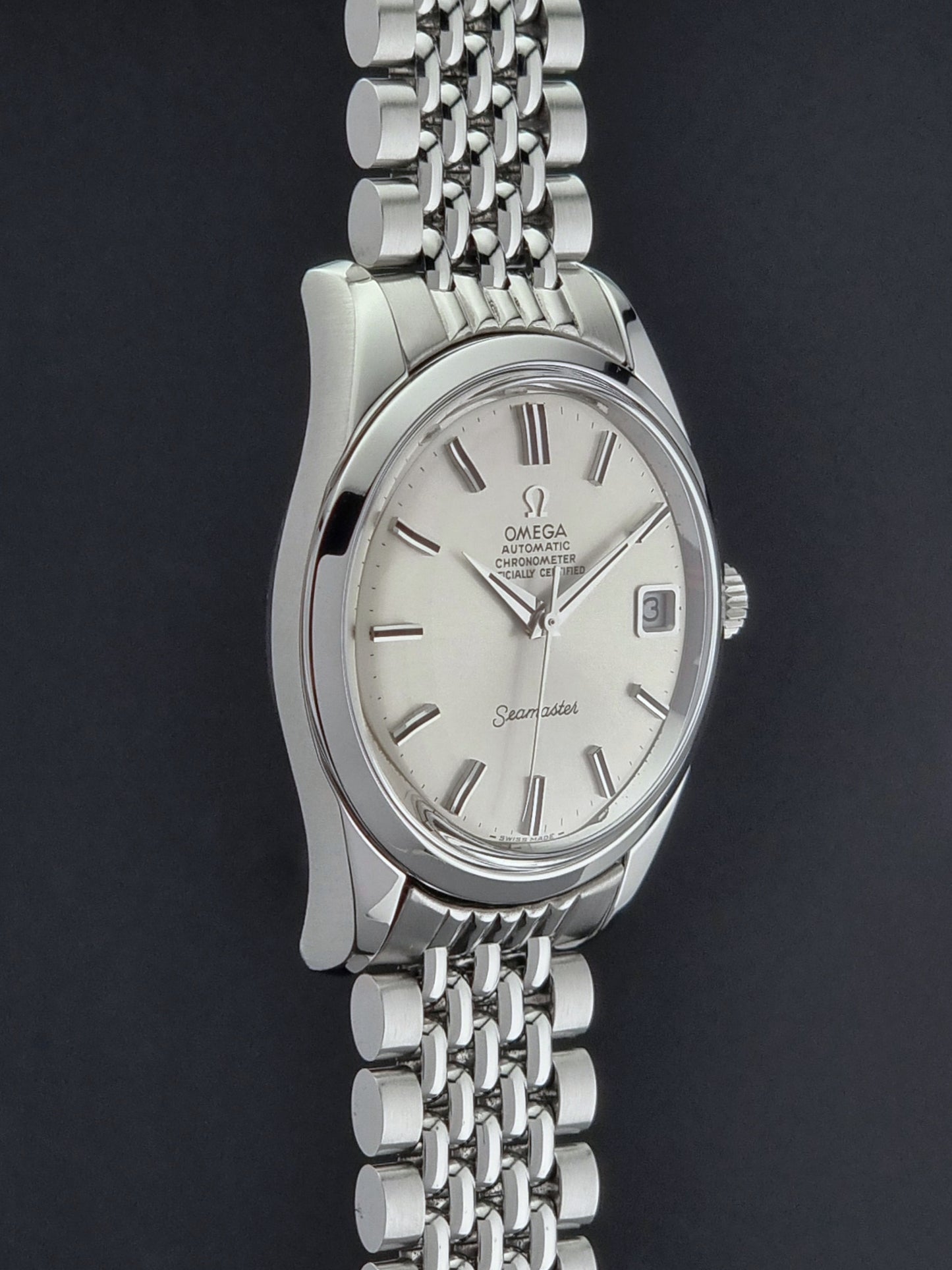 Vintage Omega Wristwatch Seamaster 166.010 watch on a dark gray background side profile view