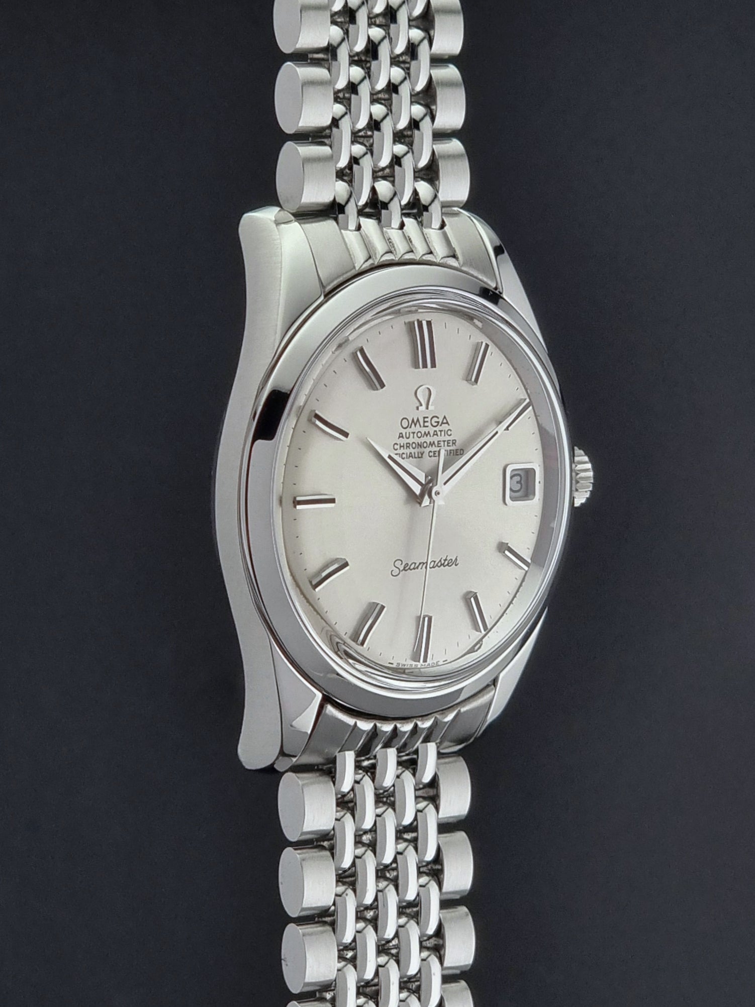 Vintage Omega Wristwatch Seamaster 166.010 watch on a dark gray background side profile view