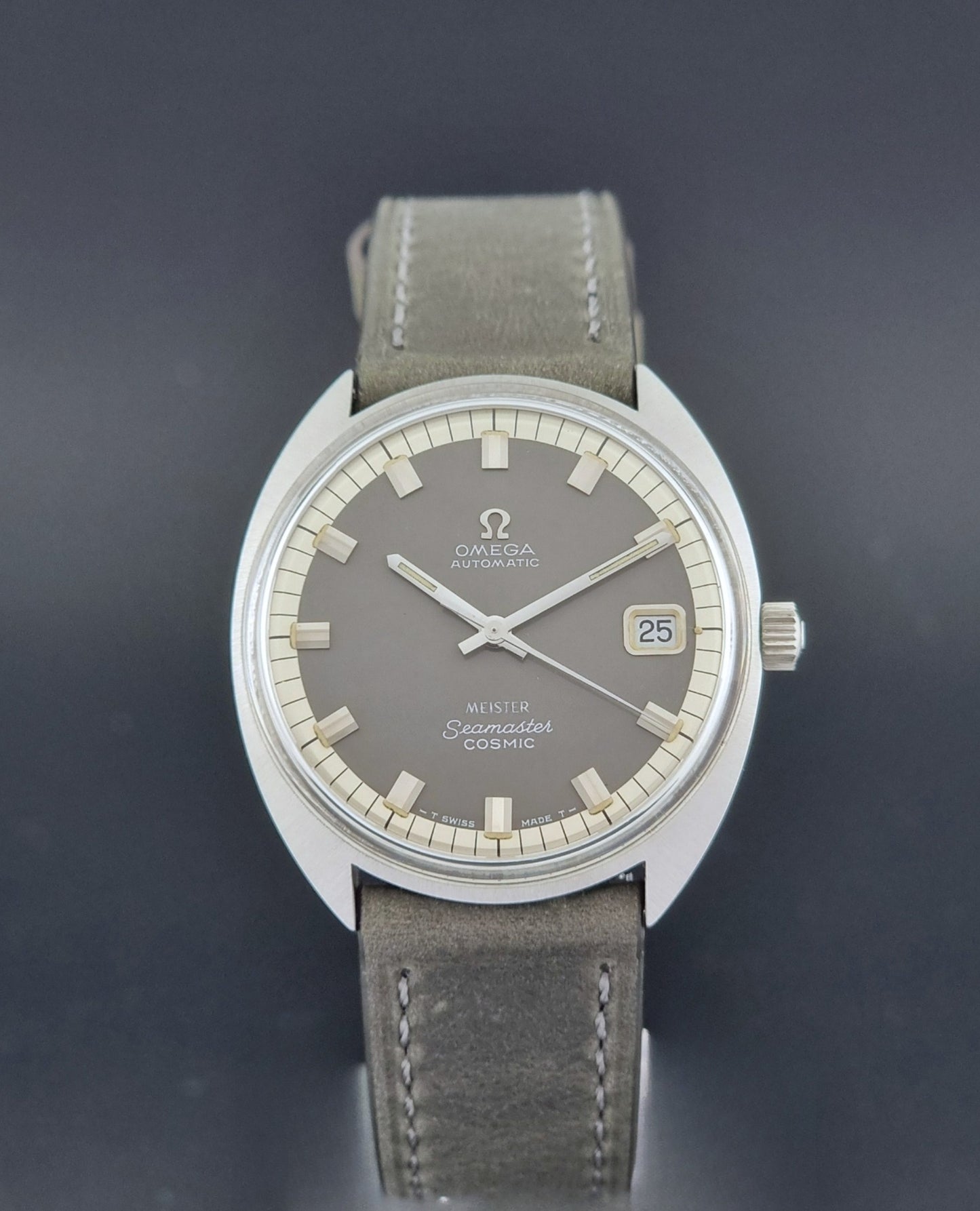 Vintage Omega Seamaster Cosmic 166.026 Wristwatch Meister Dial with leather strap on a dark gray background close dial view