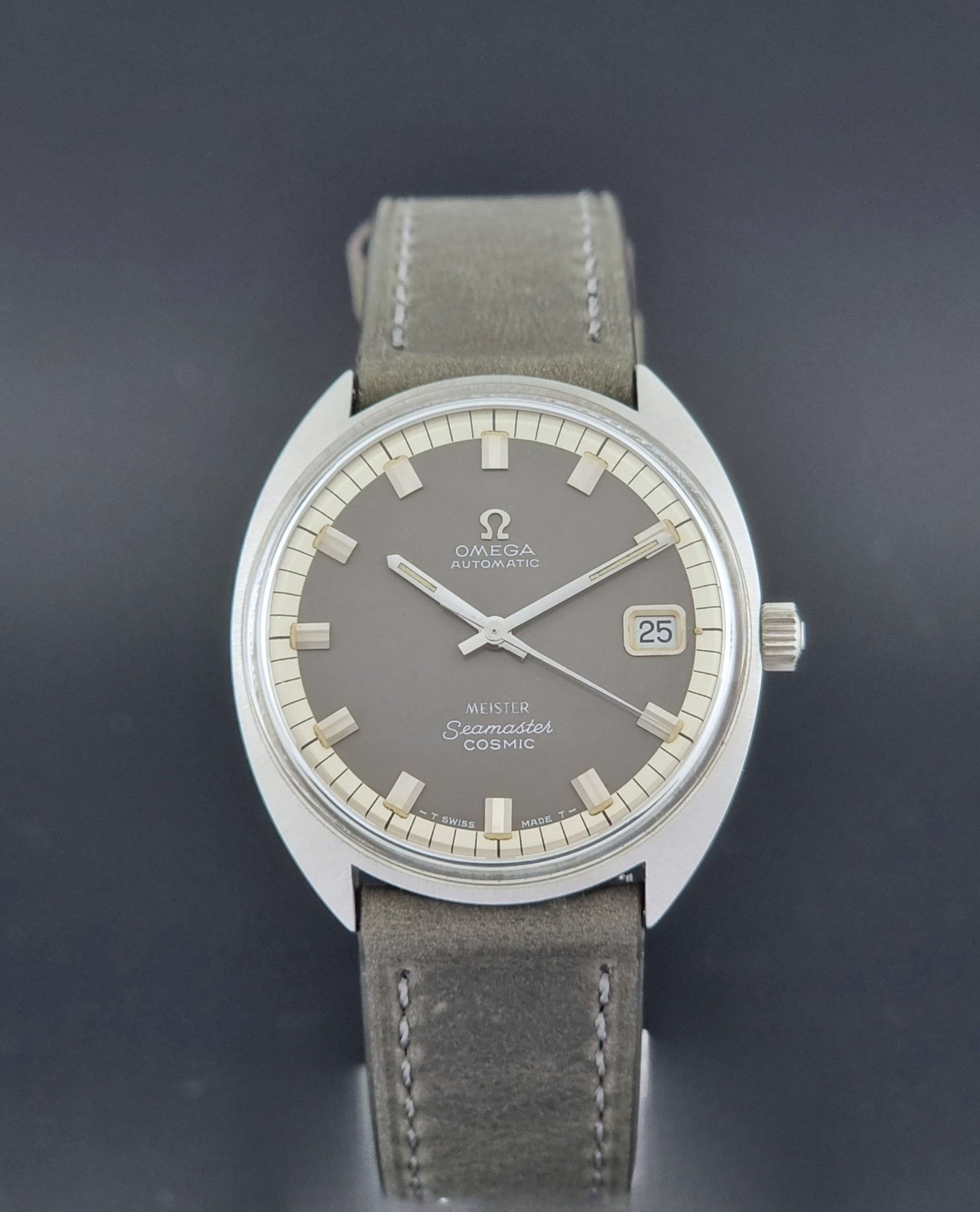 Vintage Omega Seamaster Cosmic 166.026 Wristwatch Meister Dial with leather strap on a dark gray background close dial view