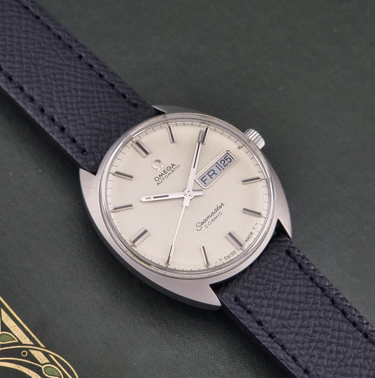 1970 vintage Omega Seamaster Cosmic 166.036 automatic watch, front view highlighting the frosted cream day-date dial