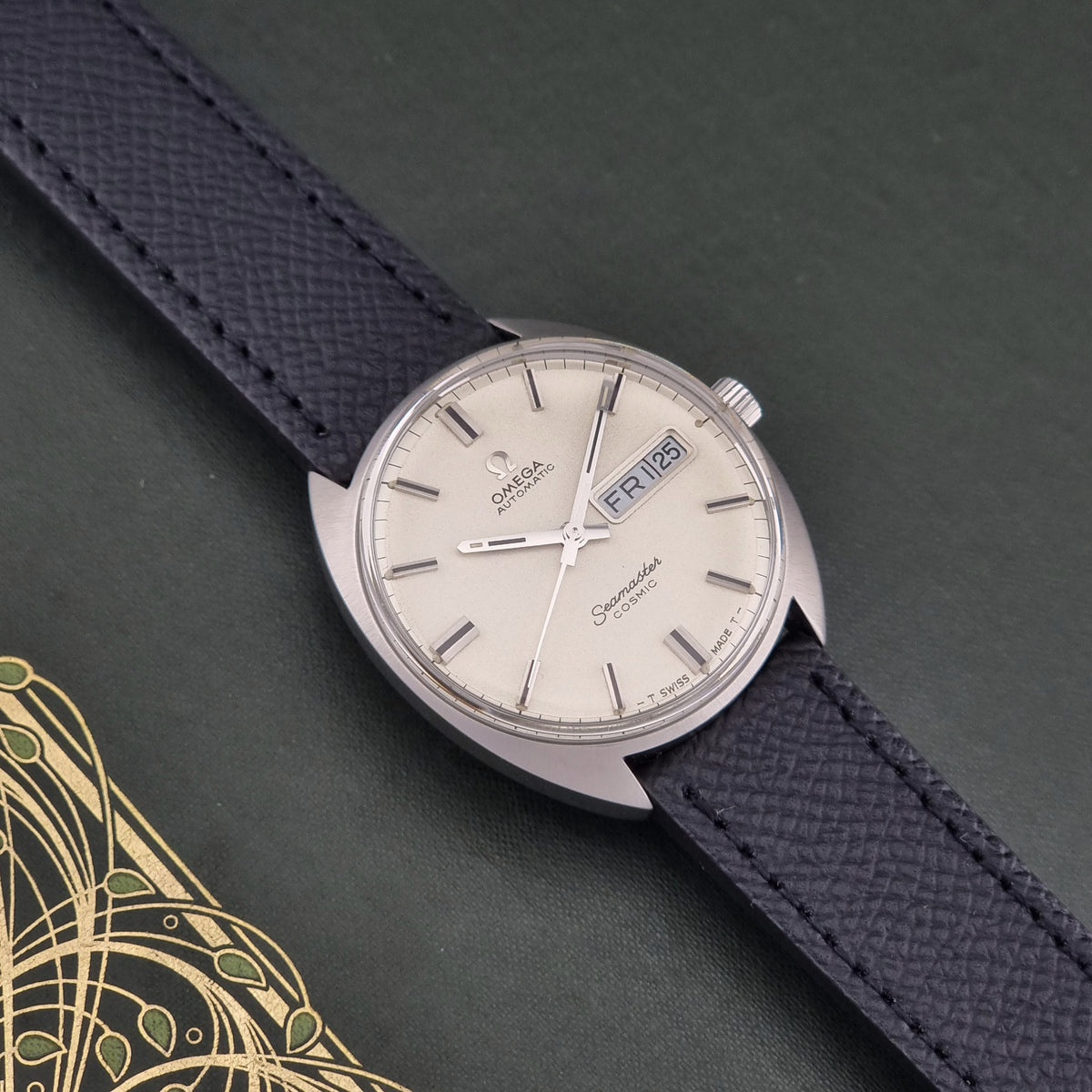 1970 vintage Omega Seamaster Cosmic 166.036 automatic watch, front view featuring the frosted cream day-date dial
