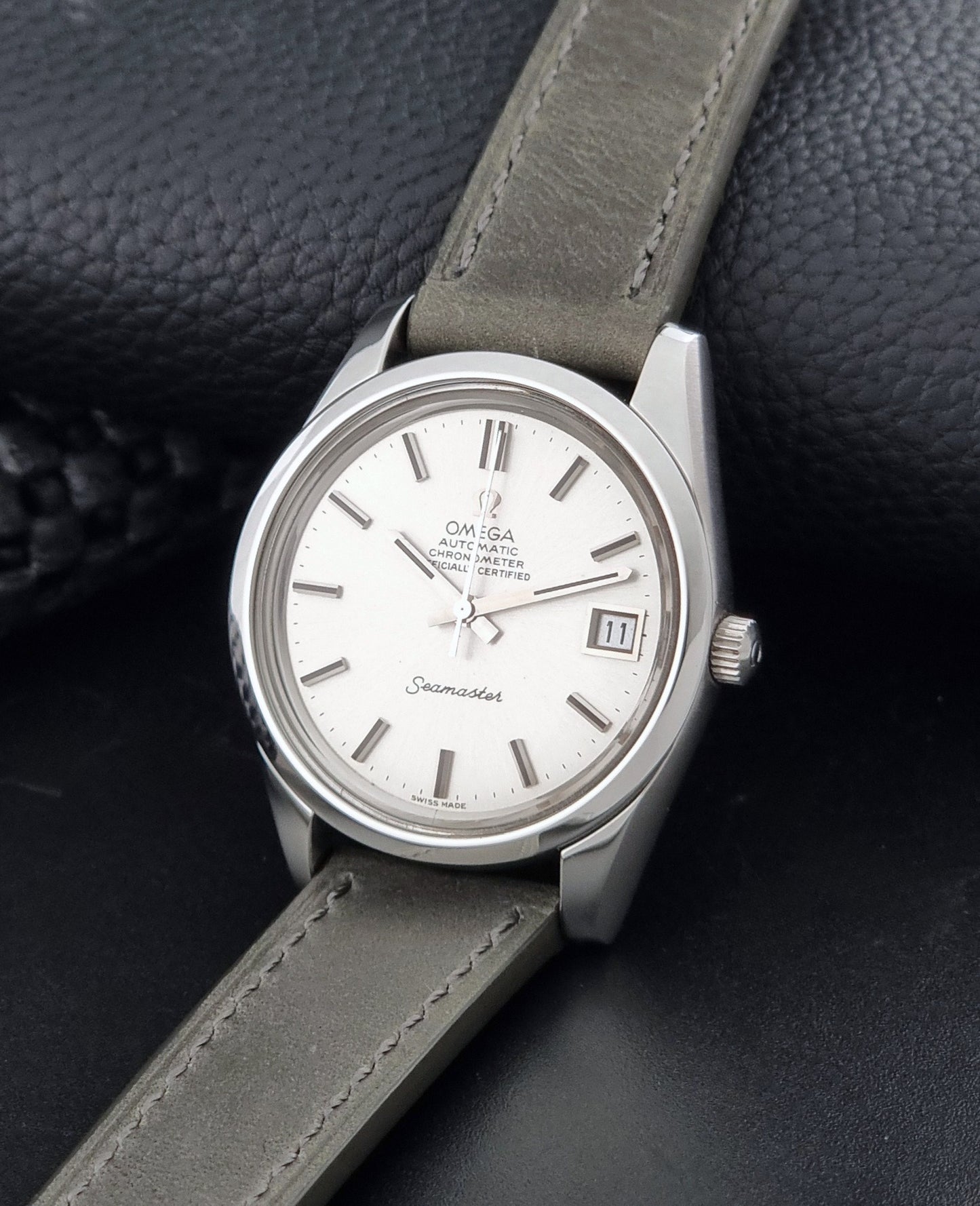 Vintage Omega Seamaster 168.0061/166.0172 watch on a grey strap and dark back ground crown view